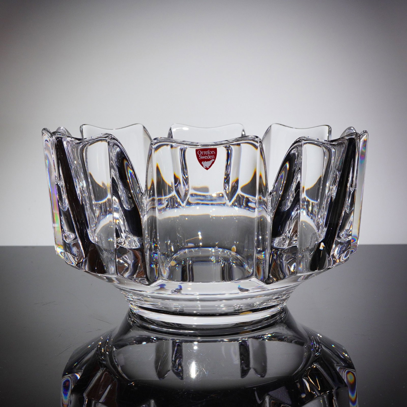 Orrefors Crystal Corona Bowl by Lars Hellsten: A single Orrefors Crystal Round Bowl in the Corona patern, designed by Lars Hellsten. The heavy clear crystal bowl features a contemporary Scandinavian design characterized by a thick body and deep, a