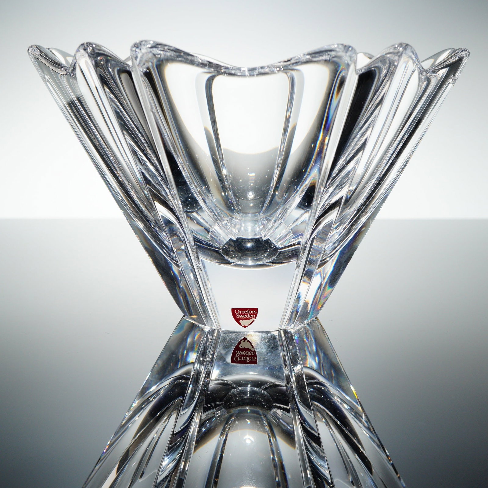 Orrefors Swedish Crystal Orion Bowl by Lars Hellsten: A single Orrefors Swedish crystal bowl, executed in the 'Orion' patern designed by Lars Hellsten. This heavy crystal glass centerpiece bowl features a modern, highly geometric form with an hourglass p