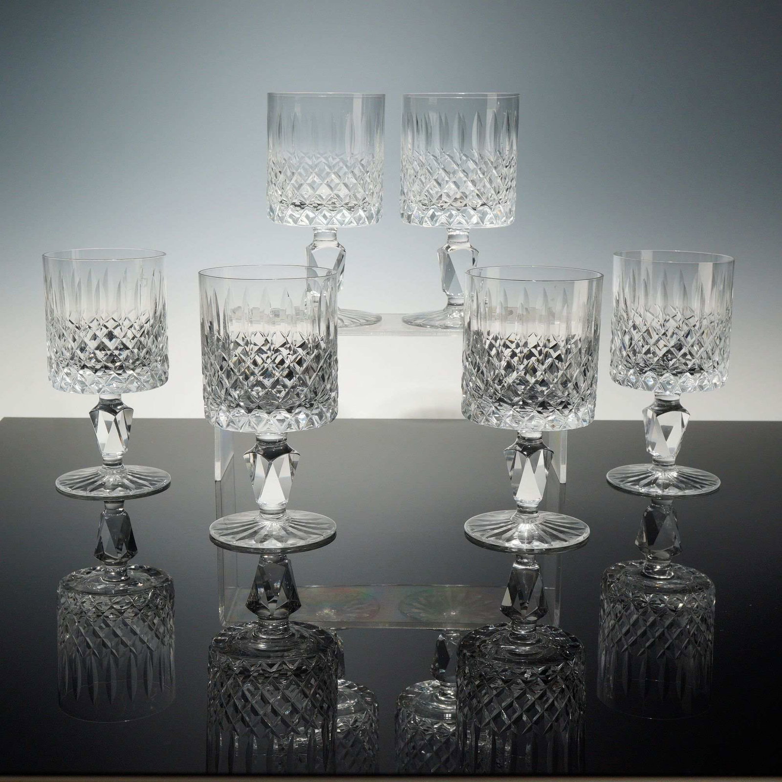 Set of 6 Waterford Crystal Wine Glasses, Lismore Simplicity: Each goblet is crafted from heavy lead crystal and features a deep bowl decorated with a horizontal band of cross-hatched diamond cutting at the base, surmounted by a row of vertical almond cuts. The 
