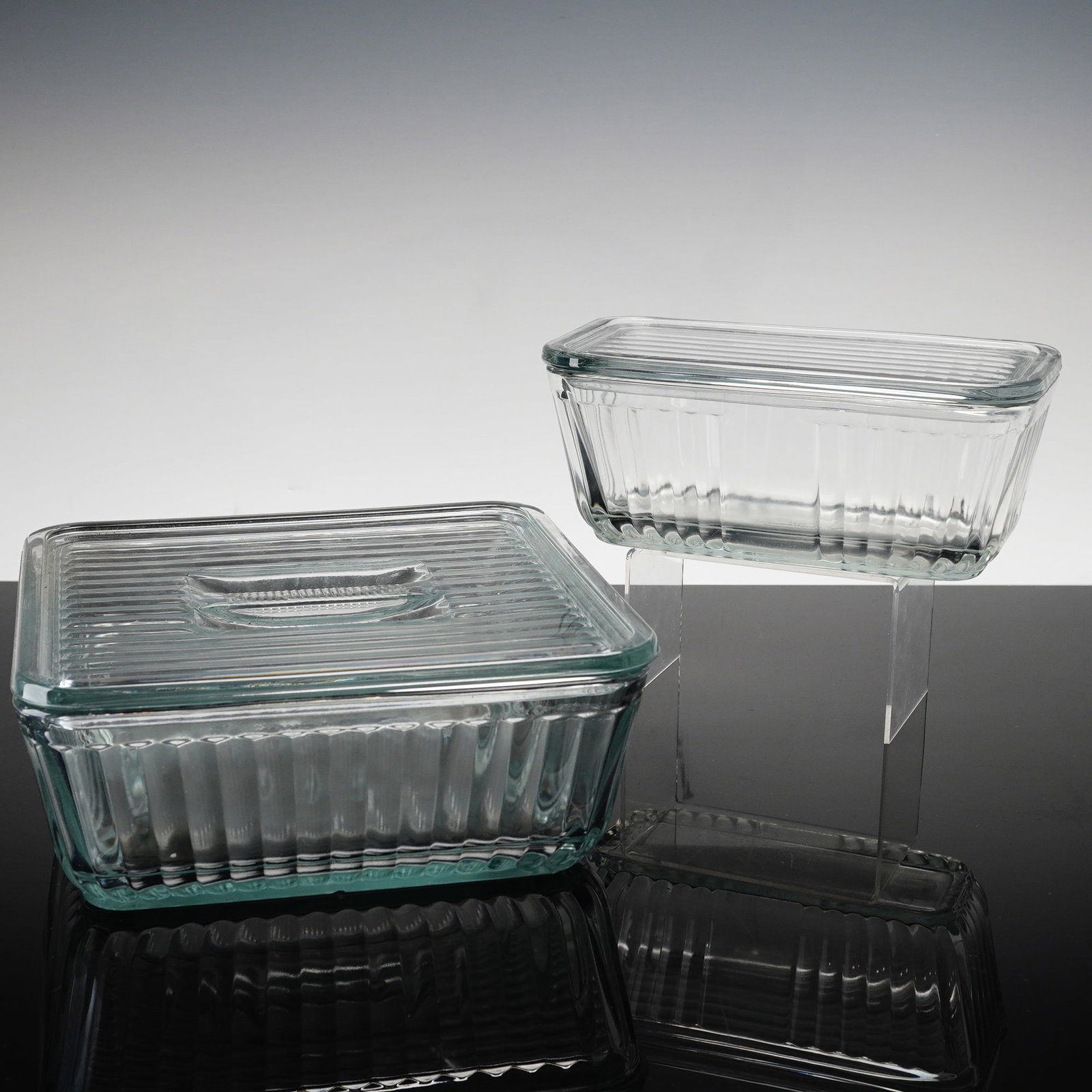 Two Anchor Hocking 1932 Vintage Design Clear Glass Refrigerator Keepers: This pair of clear pressed glass refrigerator keepers is manufactured by Anchor Hocking as part of the 1932 Vintage Design heritage collection. The set includes two rectangular storage vessels with co