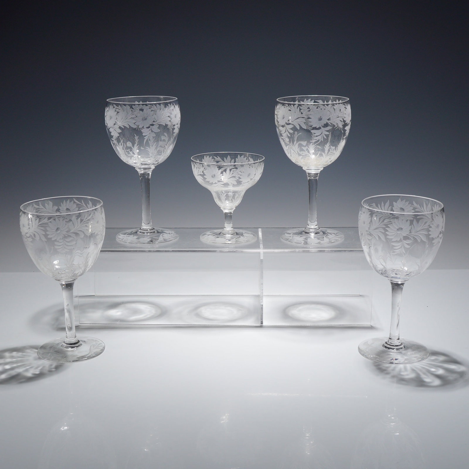 Set of 5 Fostoria Chintz Pattern Etched Crystal Stemware Glasses: A set of 5 glasses manufactured by the Fostoria Glass Company in the Chintz pattern. This collection of American lead crystal stemware includes four water goblets or large wine glasses and one low she