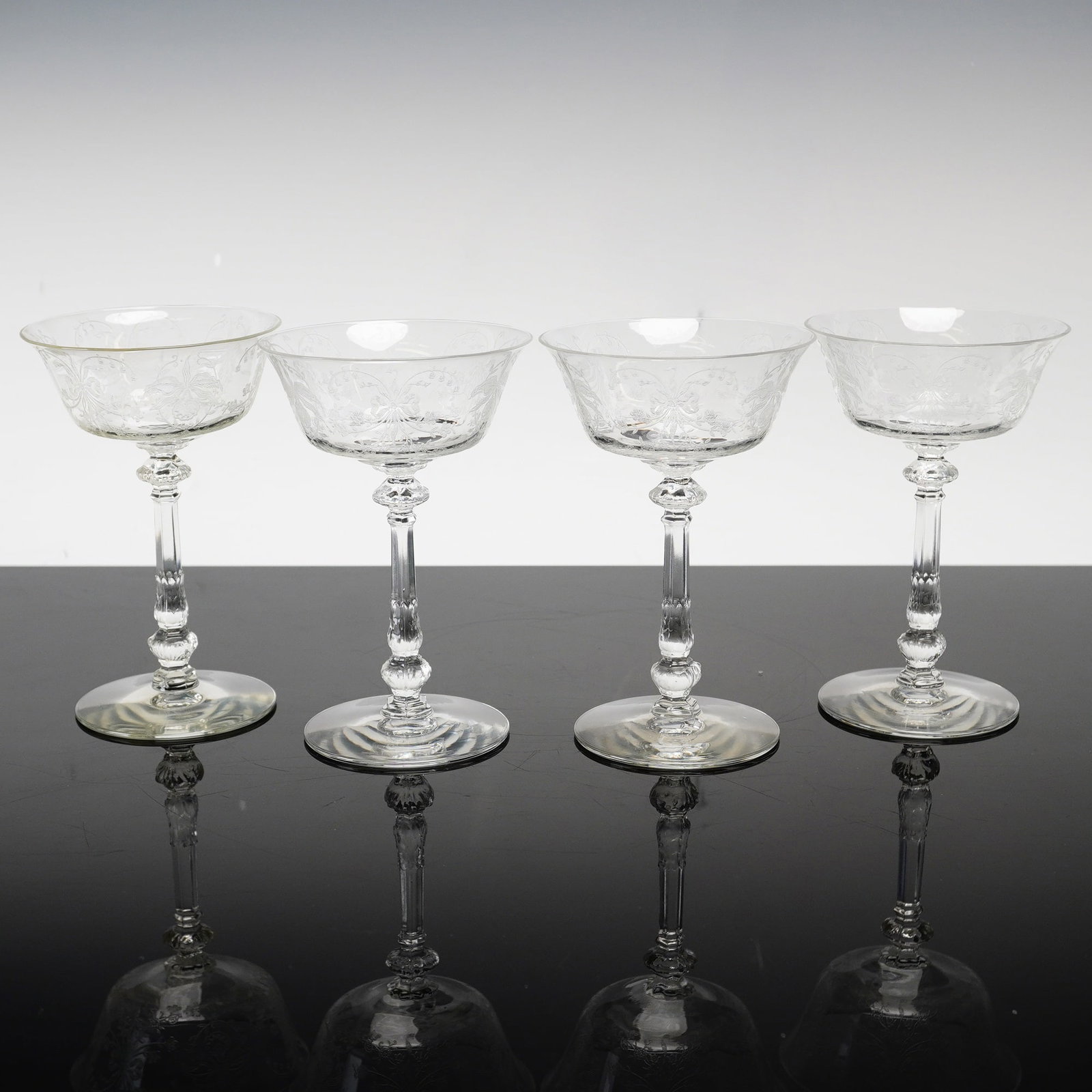 4pc Heisey Orchid Etched Crystal Champagne Coupes: This set of four clear crystal champagne coupes, also suitable for use as tall sherbets, is identified as the Orchid pattern by Heisey. The design features a flared bowl decorated with an acid-etched 
