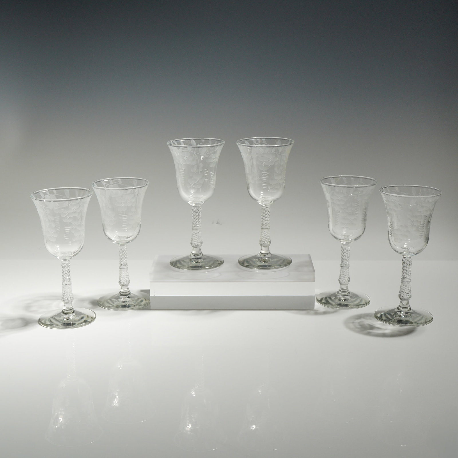 6pc Rock Sharpe Crystal Floral Etched Wine Glasses: This set of six crystal wine glasses features bowls decorated with delicate wheel-etched foliate and floral spray motifs. The stems have a distinctive twisted texture and end in plain circular feet wi