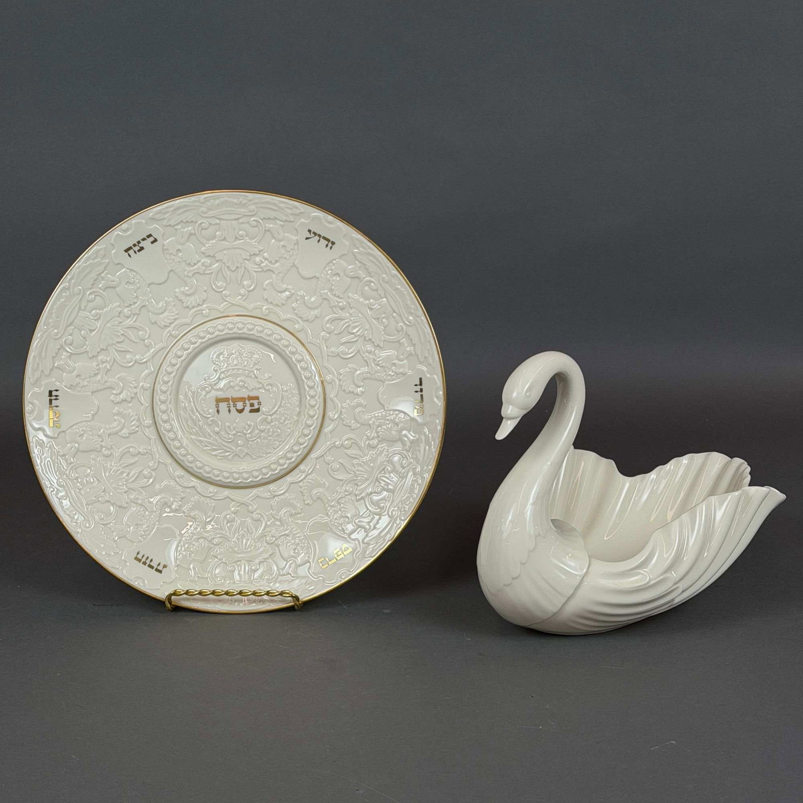 2pc Lenox Porcelain Set, Passover Seder Plate and Swan Shaped Bowl: This lot consists of a two piece set of glazed Lenox porcelain featuring a large Judaica Passover Seder plate and a matching swan shaped bowl. Both items are crafted from cream-colored porcelain with 