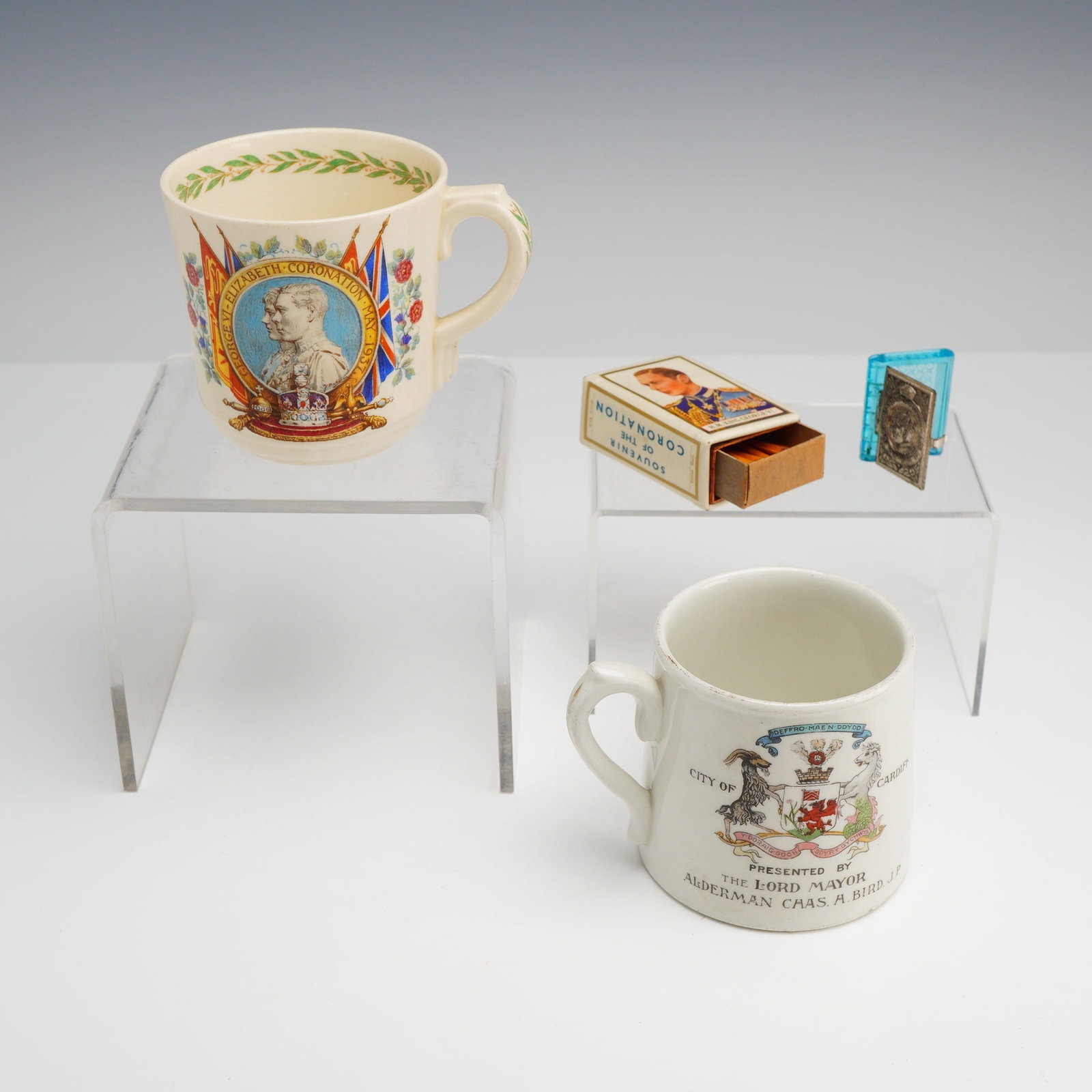 4pc British Royal George VI and Queen Elizabeth Commemorative Cups, Trinket Box & Matchbox: This collection features an assortment of British Royal commemorative pieces, including George VI and George V. The group includes a Royal Doulton earthenware mug commemorating the 1937 Coronation of 