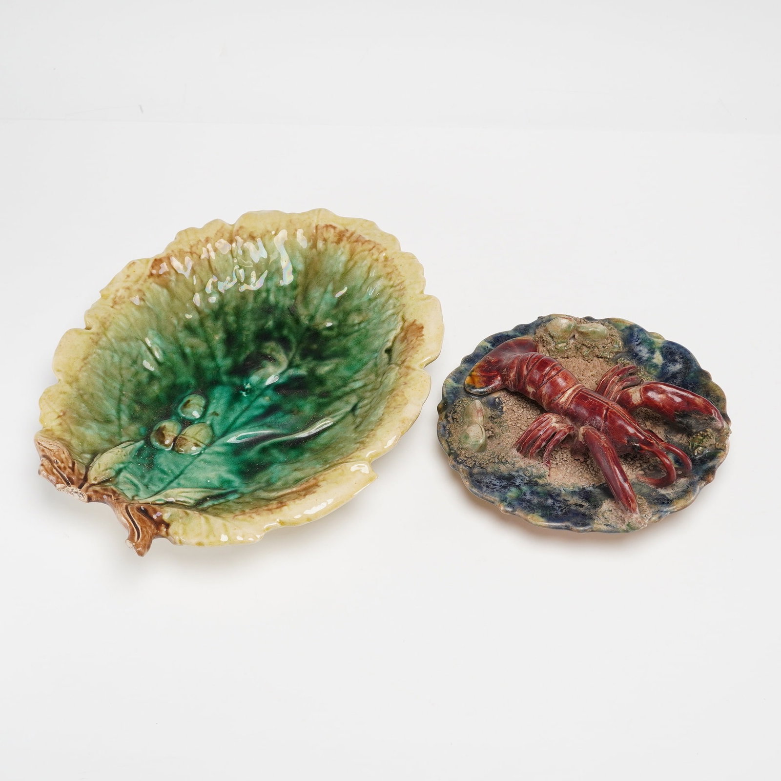 Two Majolica Earthenware Items-Begonia Leaf Dish and a Palissy Style Lobster Plaque: This lot consists of two majolica earthenware items. The first is a leaf-shaped dish in the Begonia pattern, attributed to the Etruscan Majolica line produced by Griffen, Smith and Hill. The dish is m