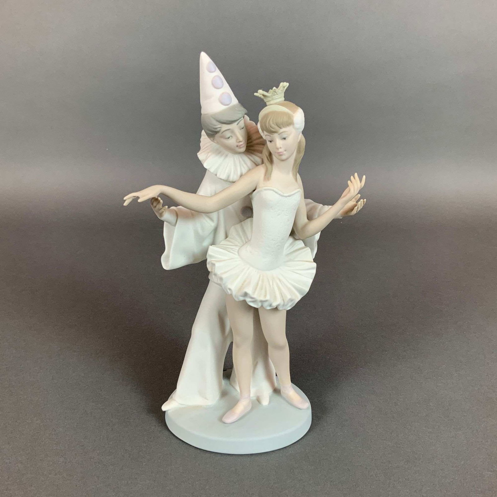 Lladro Carnival Couple Matte Porcelain Figurine Model 4882: This Lladro porcelain figurine is titled Carnival Couple, model number 4882, and was sculpted by Salvador Furio. Produced in Spain, the piece is crafted from hand-painted porcelain with a matte bisque