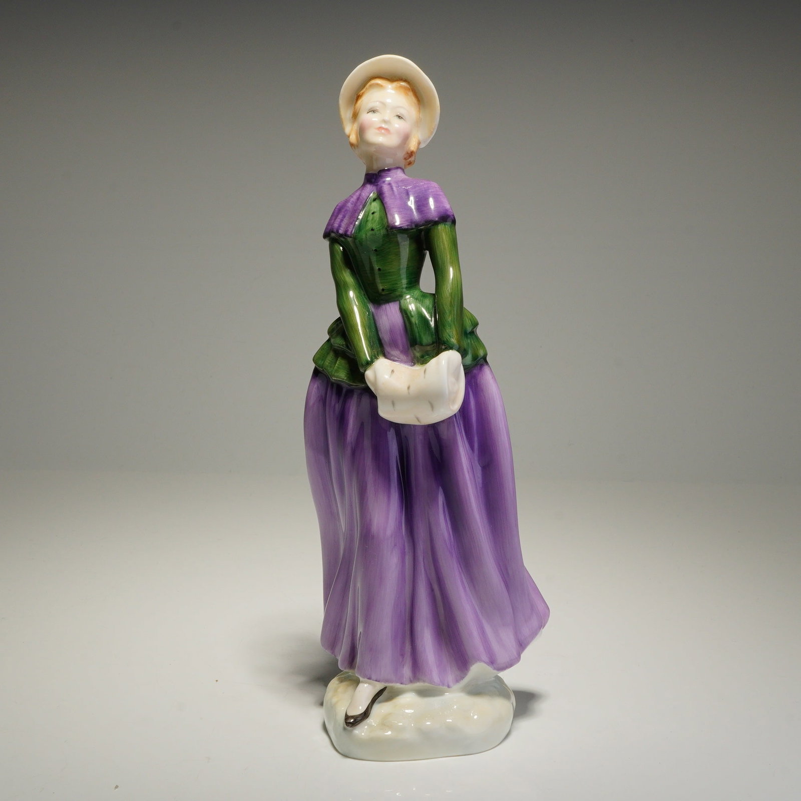 Royal Doulton Bone China Figurine, Florence HN2745: This Royal Doulton bone china figurine, titled Florence (HN 2745), is a hand-decorated figure modeled by Douglas V. Tootle. The standing female figure is depicted in Victorian-style attire, featuring 