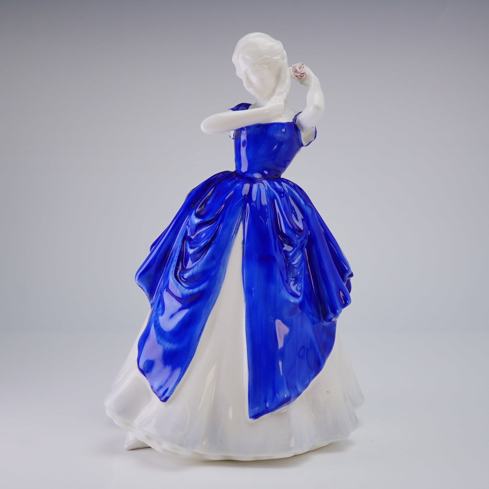 Royal Doulton Figurine, Laura HN3136 Prototype-Colorway: This Royal Doulton bone china figurine, titled Laura (HN 3136), was modeled by P. Parsons and released as a Michael Doulton exclusive in 1988. This specific piece is a prototype-colorway featuring a c