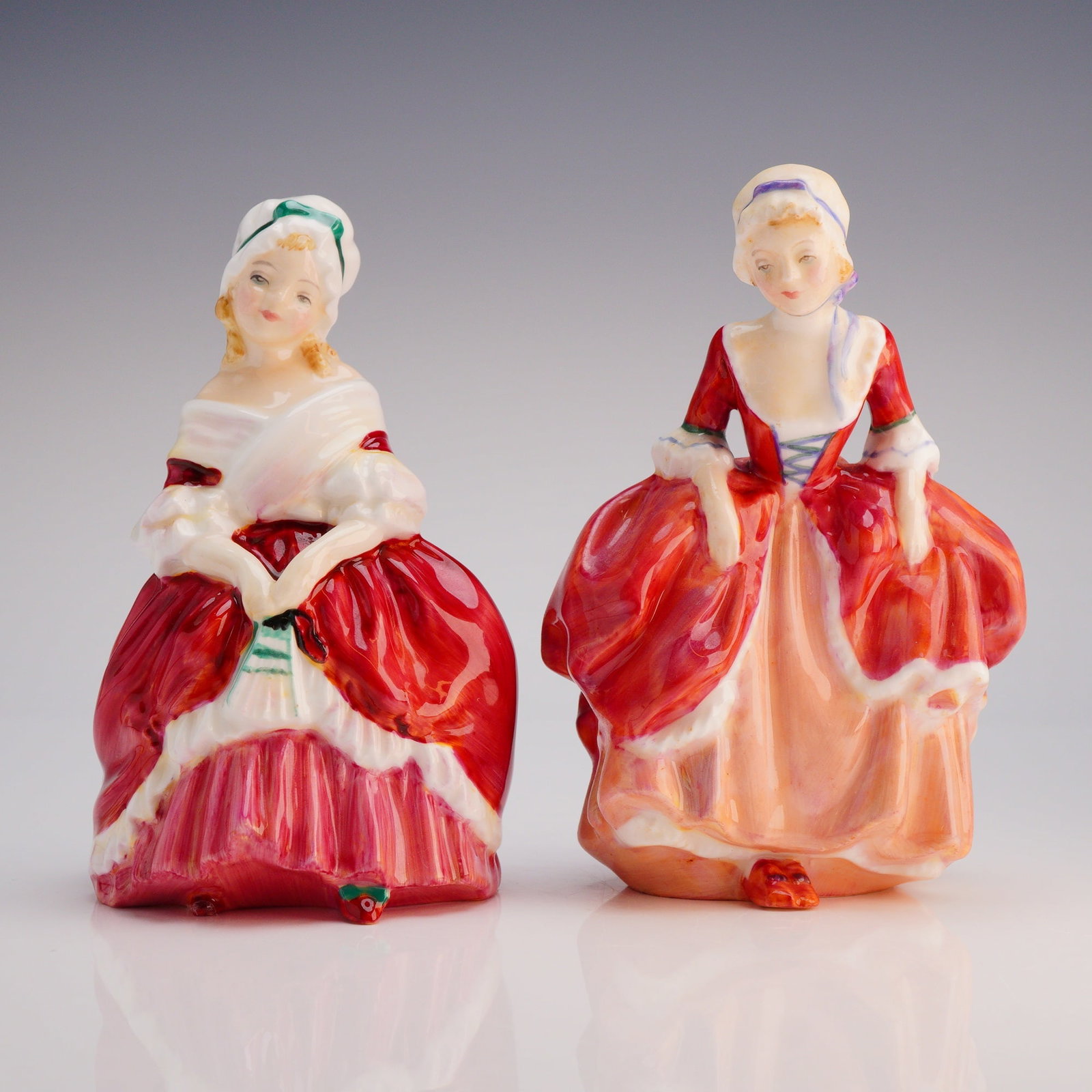 2pc Royal Doulton Figurines Peggy HN2038 and Goody Two Shoes HN2037: A pair of two bone china figurines manufactured by Royal Doulton. The collection consists of the figure "Peggy" (HN 2038, copyrighted 1948) and the figure "Goody Two Shoes" (HN 2037, copyrighted 1939)