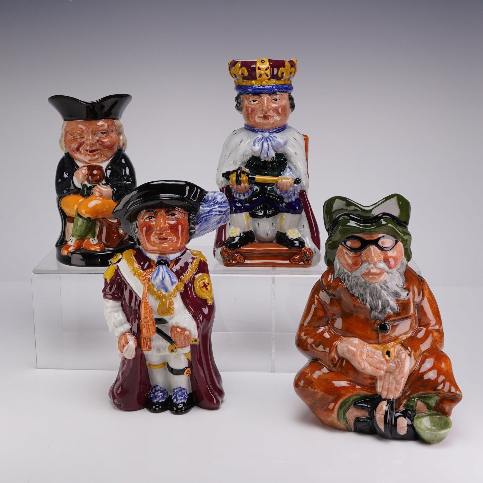 4pc Staffordshire Fine Ceramics Hand Painted Toby Jugs: This collection consists of four hand-painted earthenware Toby jugs produced by Staffordshire Fine Ceramics in England. The set includes figures titled The Publican, King, Knight Order of the Garter, 