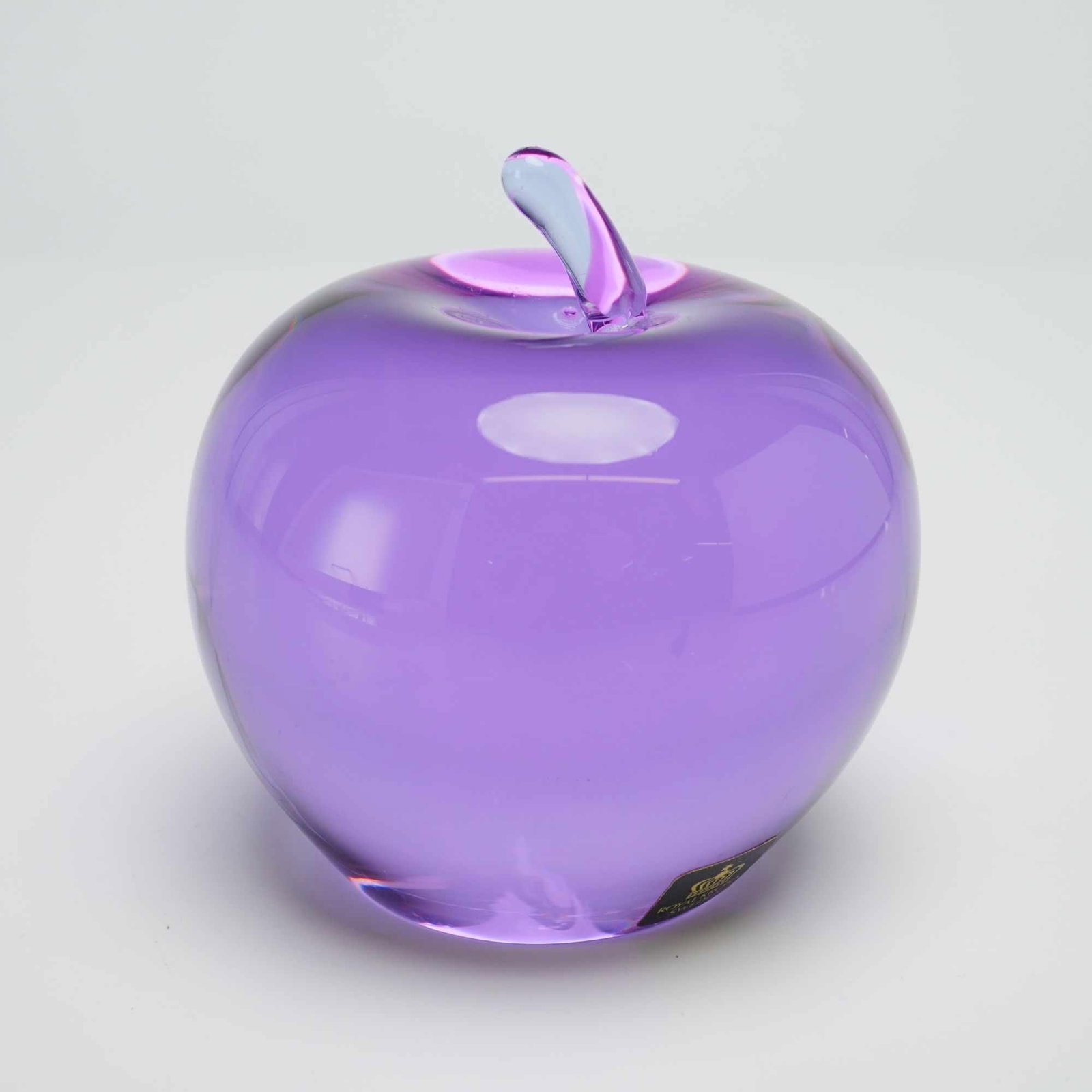 Royal Krona Sweden Amethyst Lead Crystal Apple Paperweight: A Swedish art glass paperweight in the form of an apple, produced by the M?ler?s glassworks for the Royal Krona marketing cooperative. The piece is executed in transparent amethyst-colored lead crysta