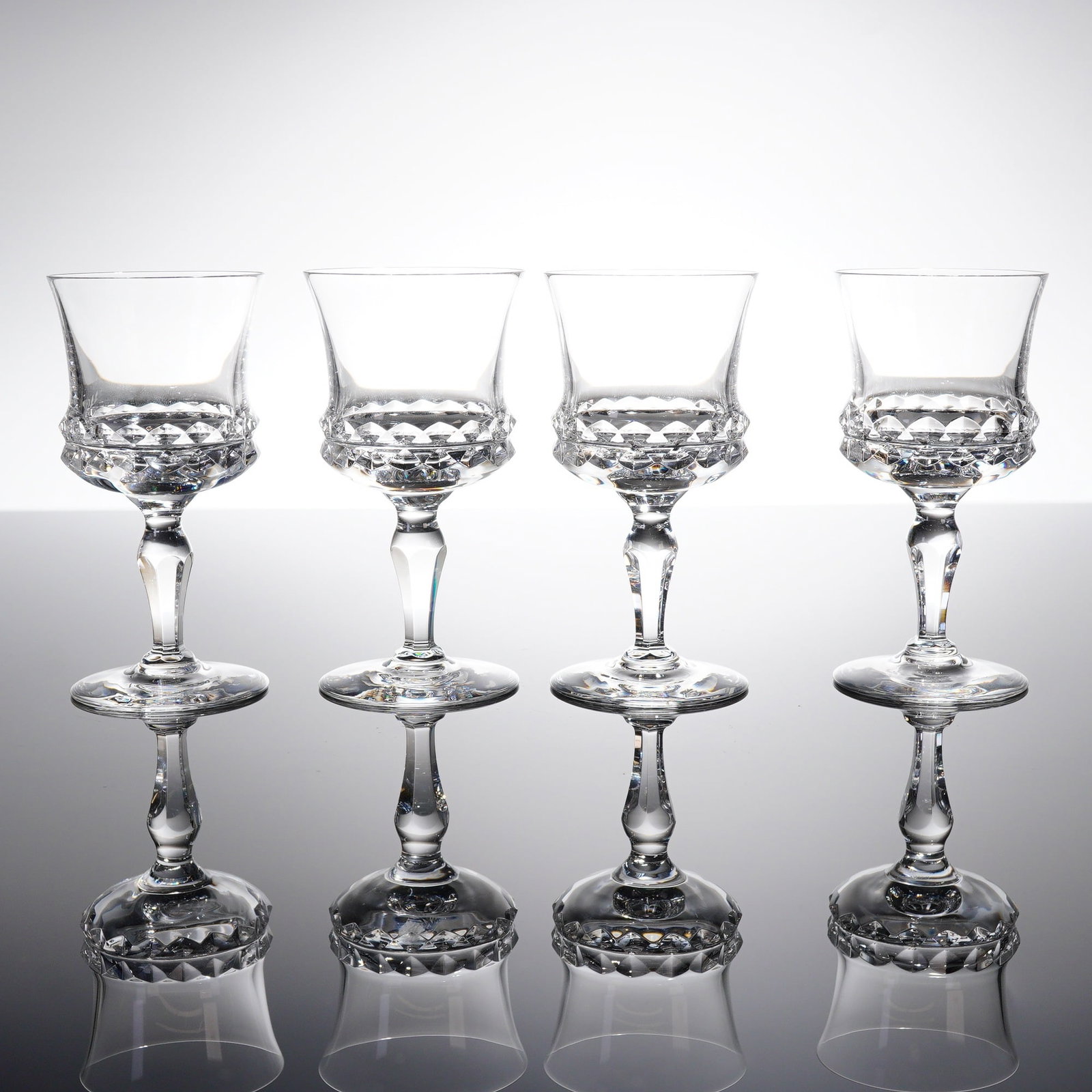Collection of Four Orrefors Silvia Crystal Sherry Glasses: A collection of four lead crystal stemmed glasses in the 'Silvia' patern by Orrefors, Sweden. These items are identifi?ed as Sherry glasses. Each glass features a tapering bowl that fi?ares slightly a
