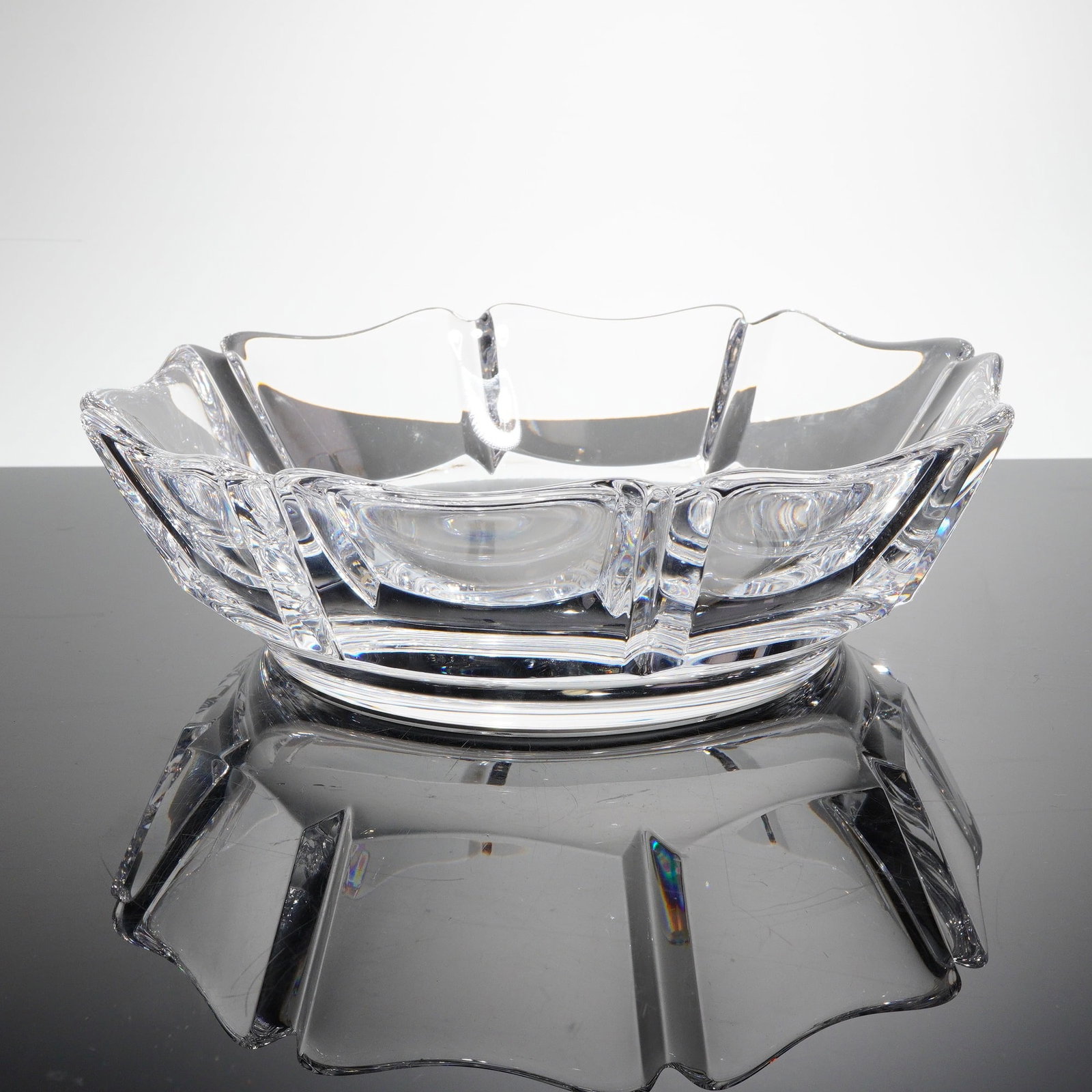 Orrefors Crystal Corona Bowl by Lars Hellsten: A single colorless cut crystal bowl atributed to Orrefors, Sweden, in the "Corona" patern, designed by Lars Hellsten. This geometric and heavy crystal bowl features a wide, shallow silhouete, consiste