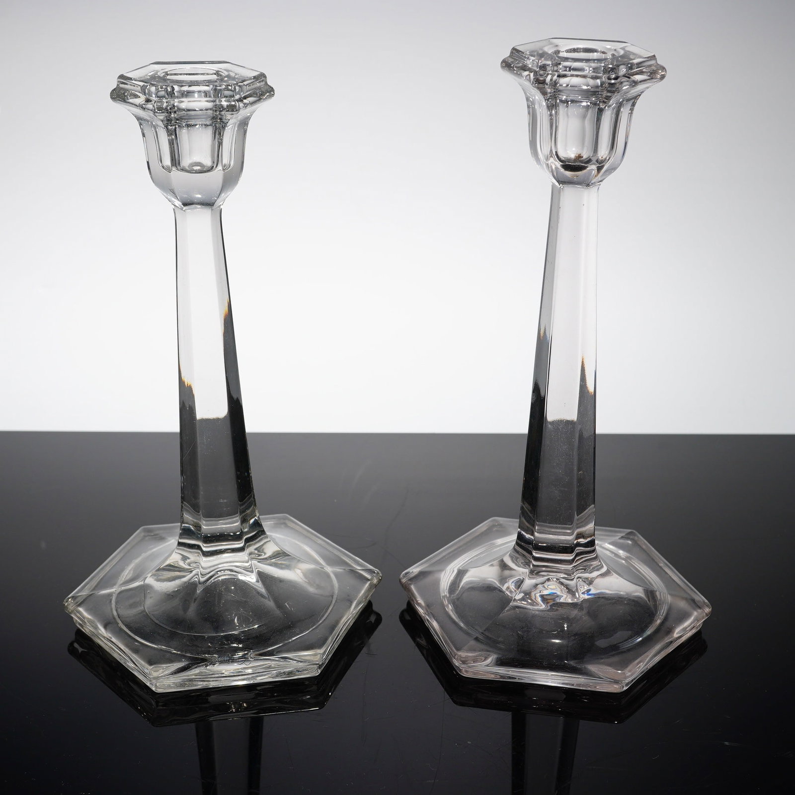 Art Deco Style Odessa Pattern Pair of Crystal Hexagonal Candlesticks: This pair of crystal hexagonal candlesticks is designed in the Art Deco style, featuring a form nearly identical to the Odessa pattern. Each candlestick is composed of a wide hexagonal base that taper