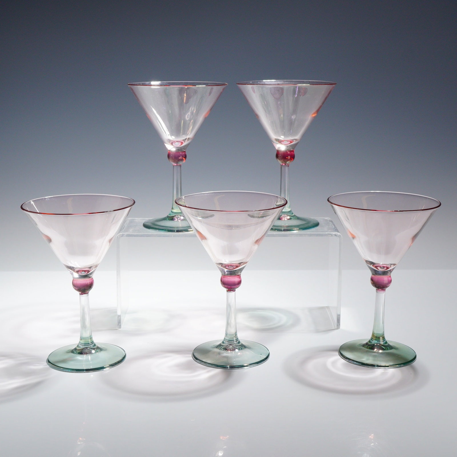 Set of 5 Italian Hand-Blown Multi-Color Art Glass Martini Glasses: A set of 5 martini glasses featuring a multi-color hand-blown glass construction. Each glass is designed with a pale amethyst-tinted conical bowl finished with a dark fuchsia-colored rim. The bowl is 