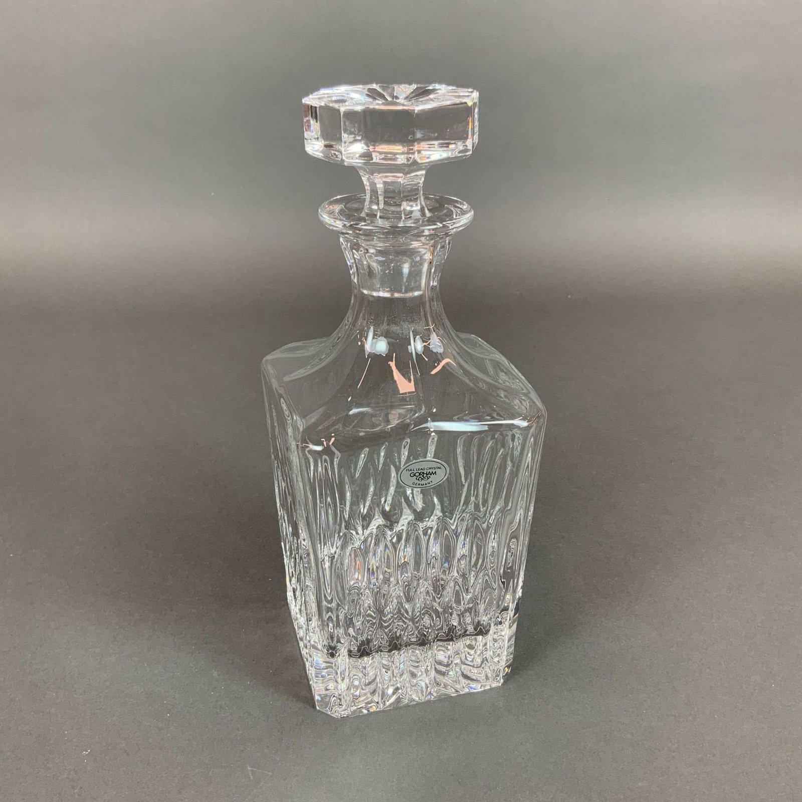 Gorham Althea Pattern Cut Full Lead Crystal Spirit Decanter and Stopper: This Gorham spirit decanter is executed in the Althea pattern and constructed from full lead crystal. The vessel features a square body with rounded shoulders and a tapered neck. The exterior walls ar