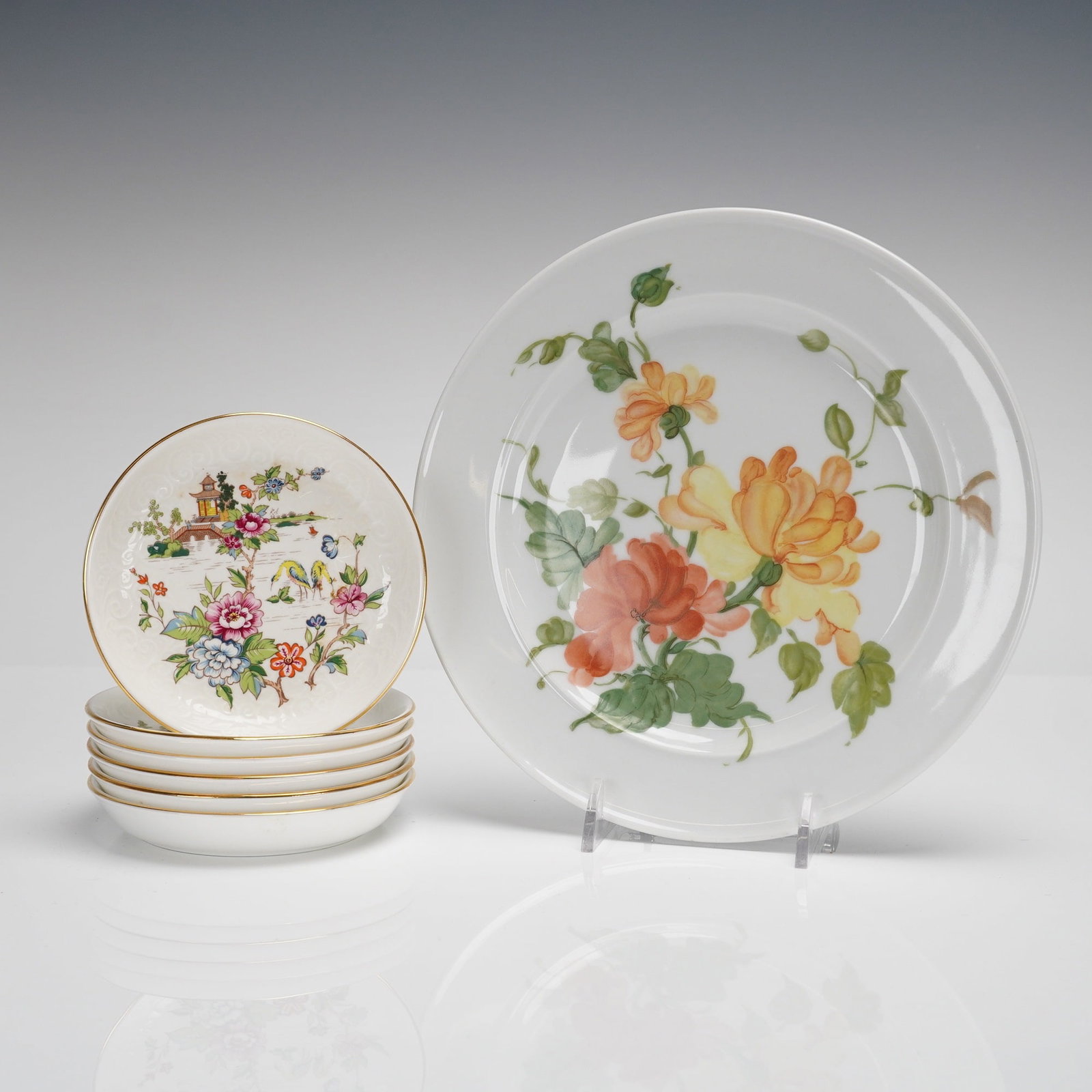 Coll. of 7 Kaiser Lauriane & Crown Staffordshire Pagoda Plates & Saucers: A collection of 7 pieces of porcelain tableware, representing two distinct manufacturers and patterns. The lot includes one large display plate by Kaiser and six small saucers by Crown Staffordshire. 