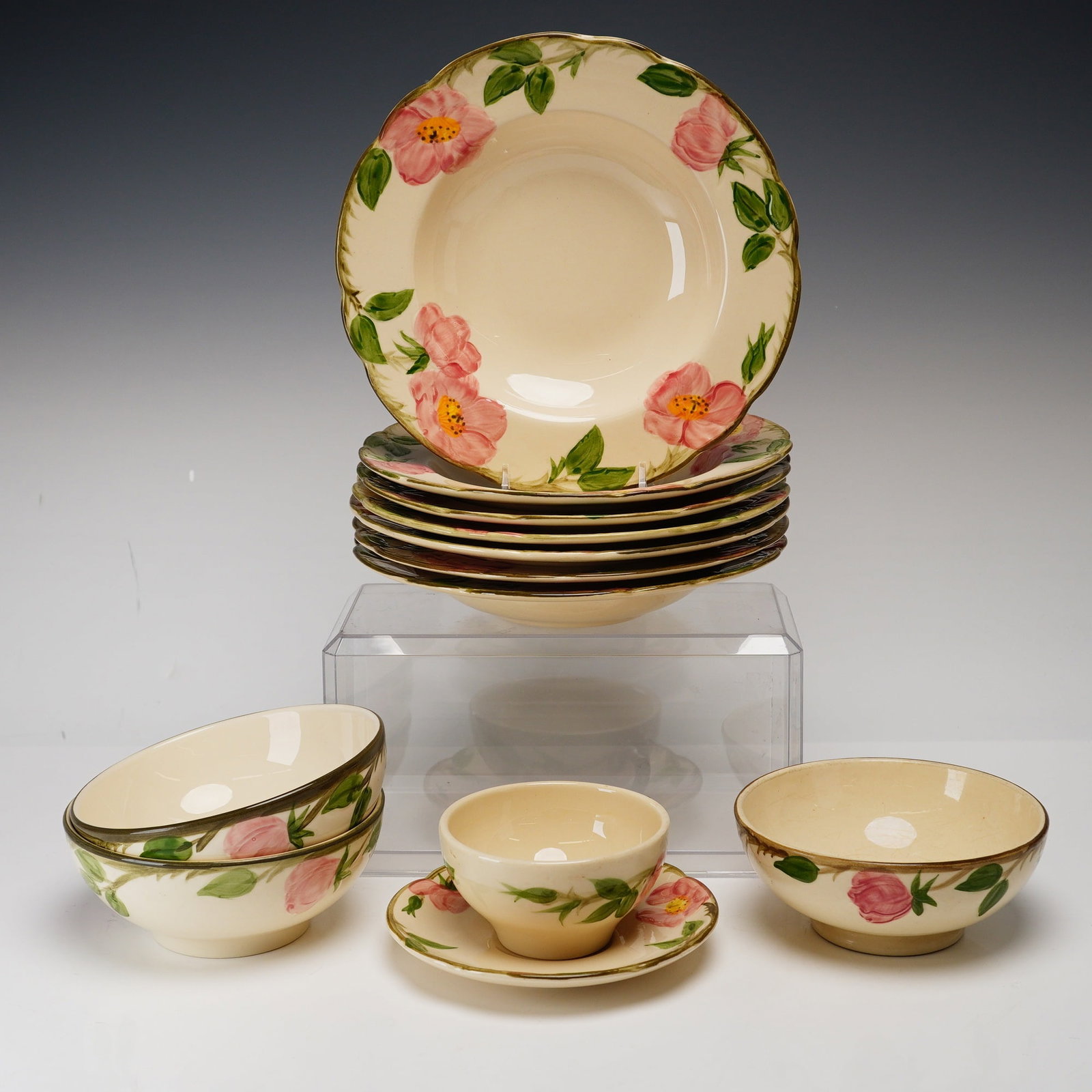 12pc Franciscan Desert Rose Pattern Earthenware Tableware Set: This set of earthenware tableware is manufactured by Franciscan in the Desert Rose pattern. This collection comprises seven rimmed soup bowls, three deep round bowls, one teacup, and one saucer. The d