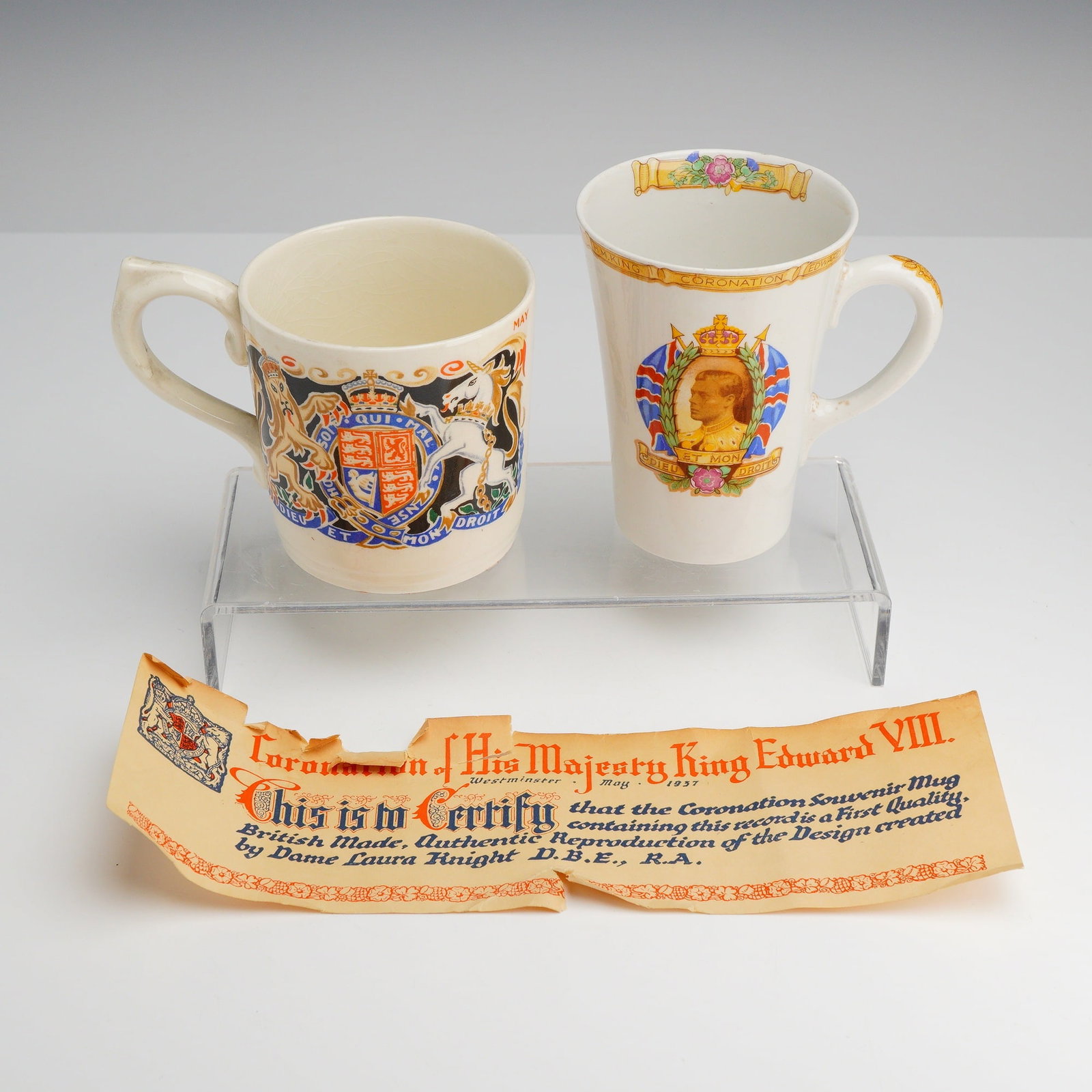 Two King Edward VIII 1937 Coronation Commemorative Mugs: This lot consists of two ceramic commemorative mugs produced for the planned coronation of King Edward VIII, which was scheduled for May 12, 1937, but never took place due to his abdication. The first