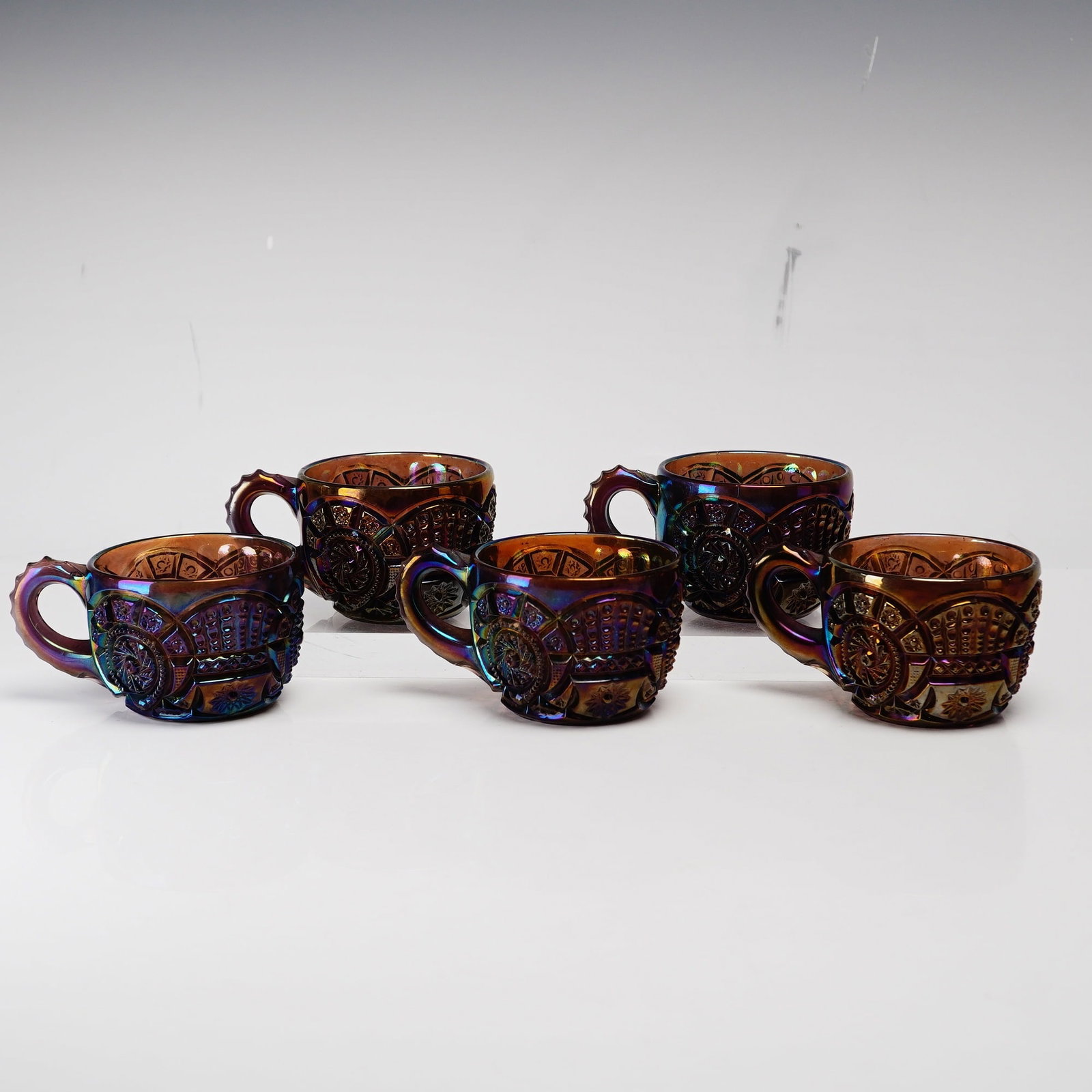 5pc Imperial Broken Arches Pattern Carnival Glass Punch Cups: This set of five punch cups is produced in the Broken Arches pattern by the Imperial Glass Company. Each piece is constructed from pressed amethyst base glass featuring a vibrant iridescent carnival f