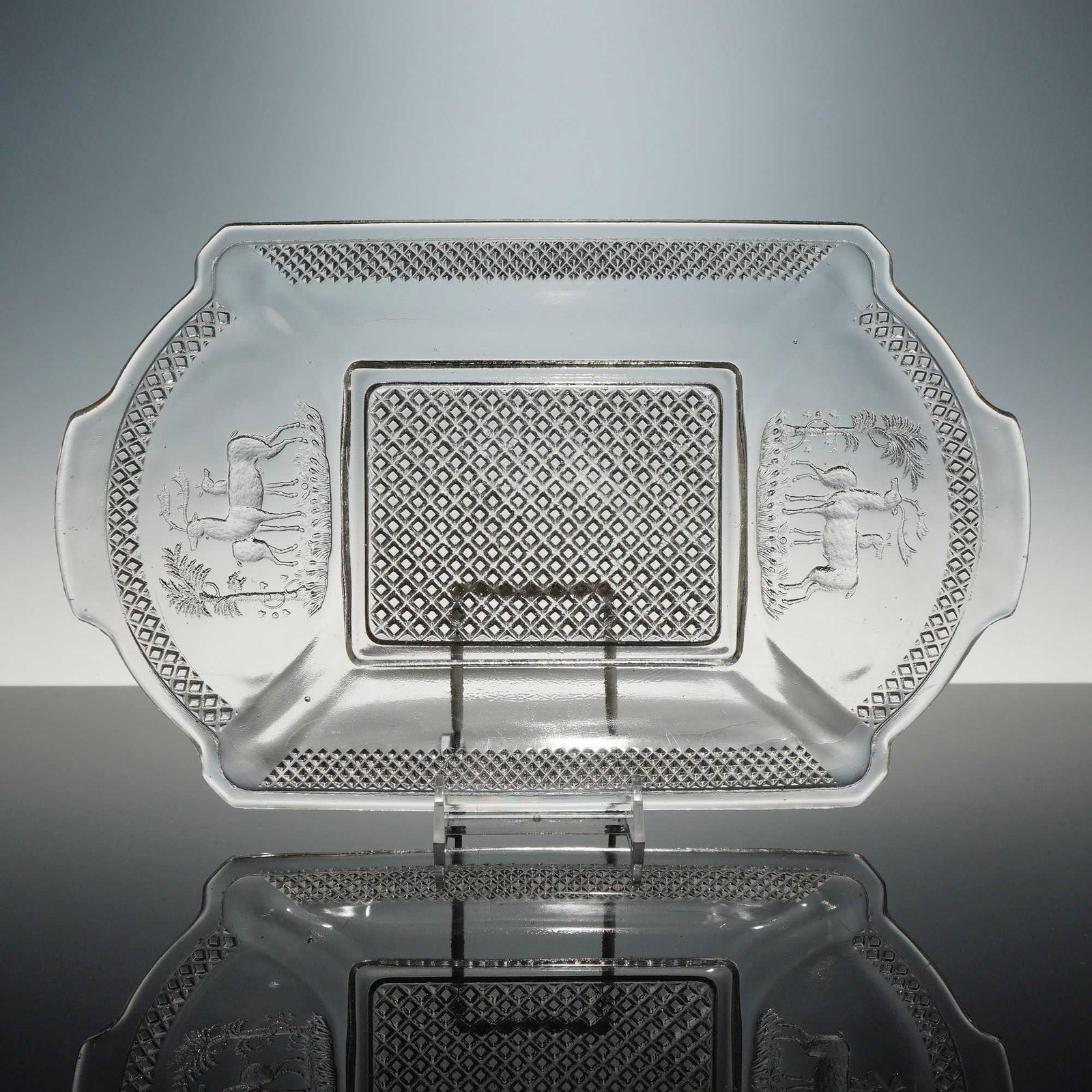 McKee and Brothers Deer and Pine Tree Pattern EAPG Platter: This rectangular clear glass eapg platter is attributed to McKee and Brothers, featuring the Deer and Pine Tree pattern, circa 1884. The item is constructed using the mold-pressed technique. The form 