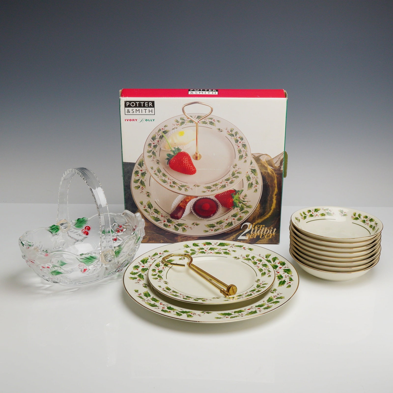 10pc Potter and Smith China and Glassware, Holly Pattern: This collection of festive holiday tableware features the Ivory-Holly pattern by Potter and Smith. The ceramic items are manufactured from fine china with an ivory-colored ground, decorated with a tra