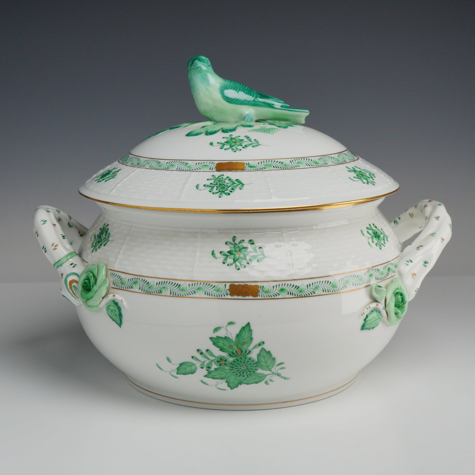 Herend Chinese Bouquet Green Porcelain Covered Tureen: A Herend fine porcelain covered tureen or vegetable dish decorated in the Apponyi Green pattern, also known as Chinese Bouquet Green. The round, deep vessel features a molded basketweave ozier relief 
