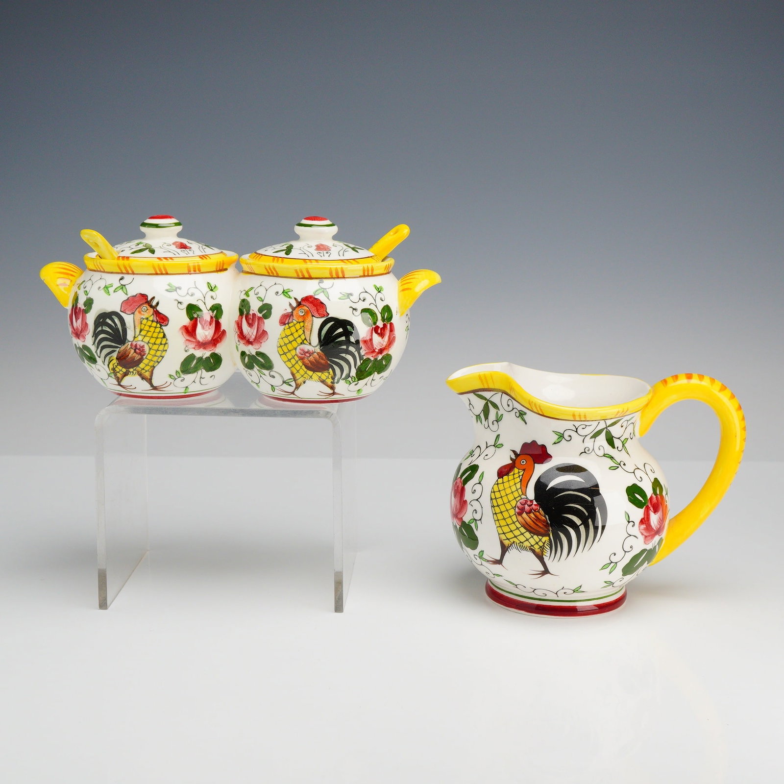 2pc PY Ucagco Ceramic Rooster Pitcher and Roses Condiment Dish: This set of Japanese earthenware is decorated in the Early Provincial pattern, featuring a rustic motif of roosters and roses. The collection includes a double-lobed lidded condiment server, identifie
