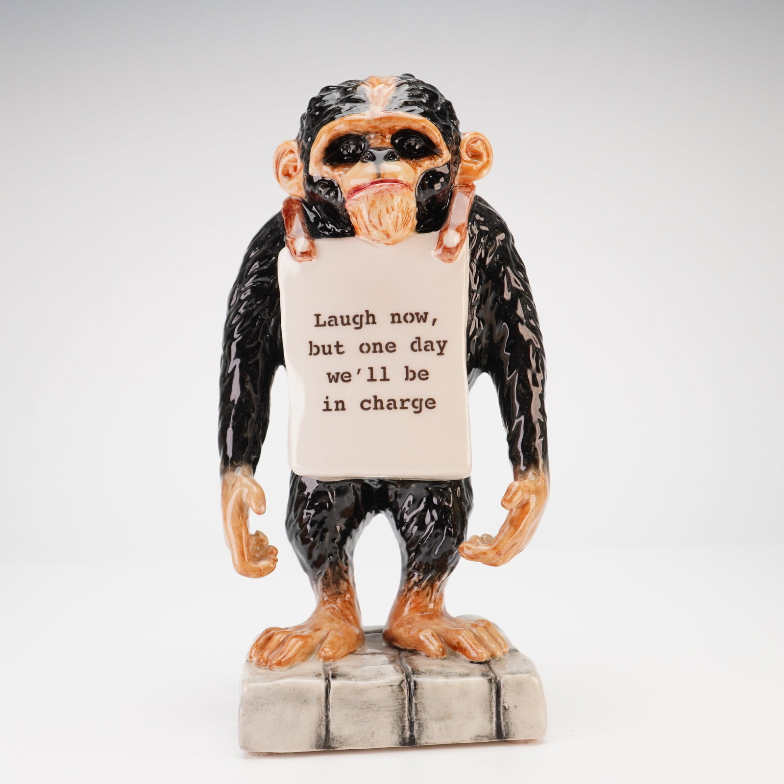 Kevin Francis Ceramics Street Art Banksy Monkey Laugh Now Limited Edition Figurine: A glazed ceramic figurine from the Kevin Francis Ceramics Street Art series, titled Banksy's Monkey: Laugh Now. This hand-made piece depicts a standing chimpanzee wearing a sandwich board, inspired by