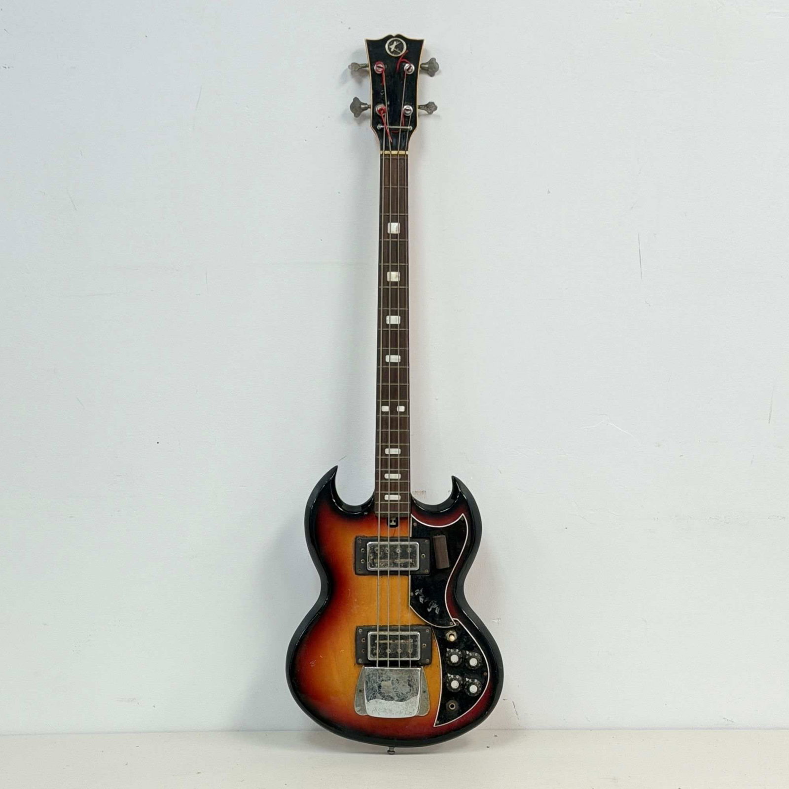 Vintage Kay K-2B Sunburst Electric Bass Guitar: A vintage four-string Kay model K-2B electric bass guitar, manufactured in Japan during the early 1970s. The instrument features a double-cutaway body design in a classic three-color sunburst finish, 