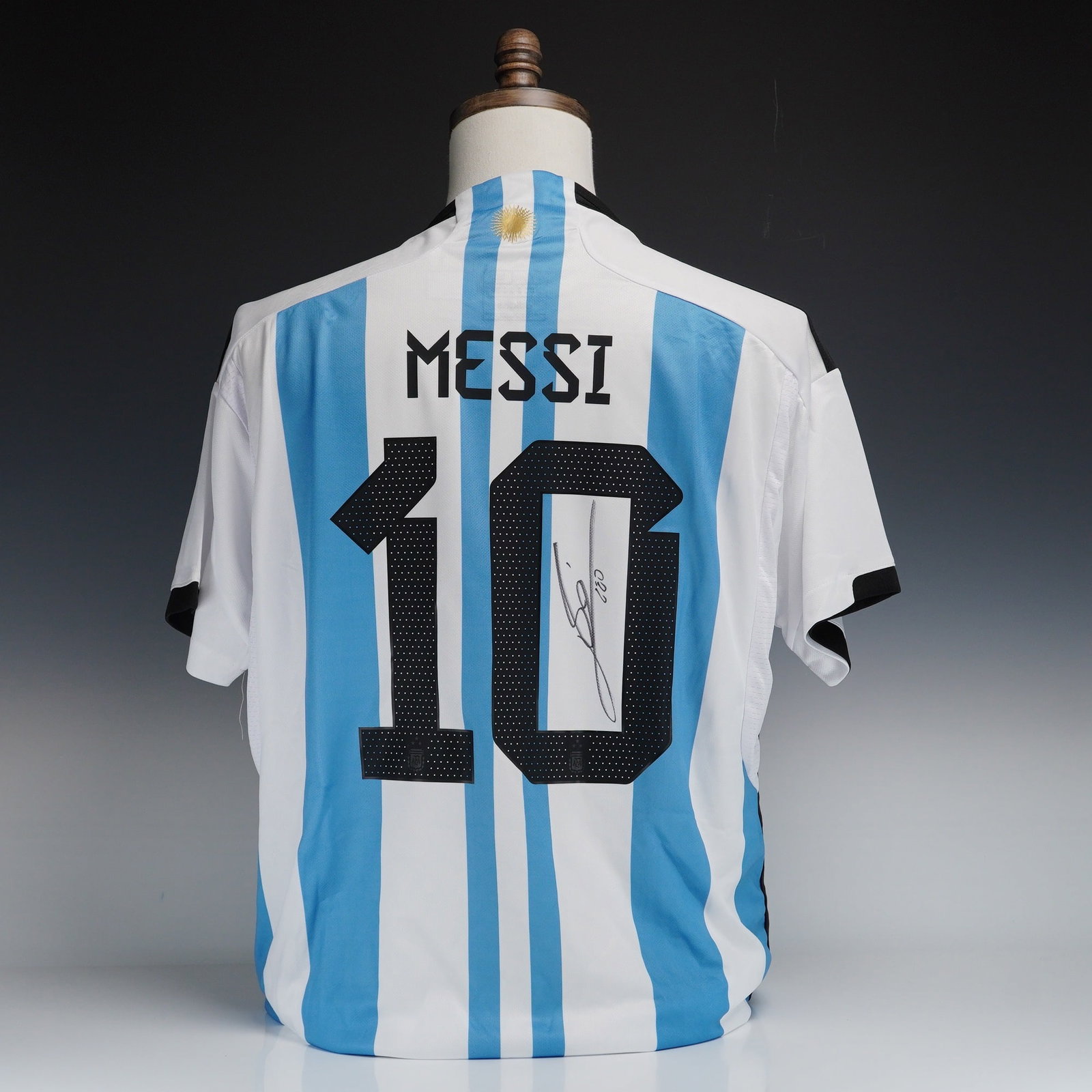 Signed Lionel Messi Argentina National Team 2022-23 Home Jersey with COA: This lot features an official 2022-23 Argentina National Team home soccer jersey, a significant piece of sports memorabilia. The shirt is designed with the traditional light blue and white vertical st