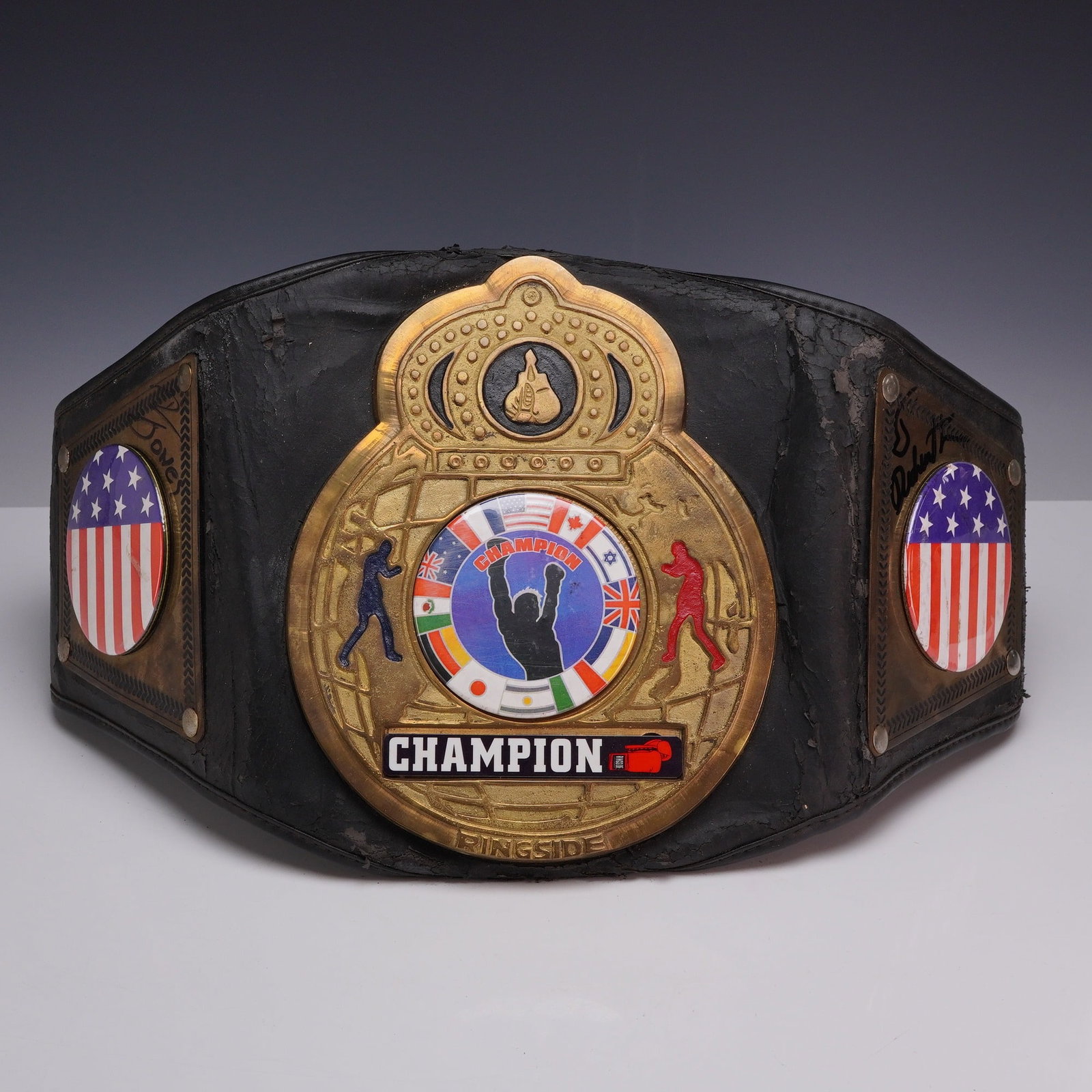 Ringside Deluxe Boxing Championship Trophy Belt, Signed: A full-size deluxe boxing championship trophy belt manufactured by Ringside. The belt features a large, ornate gold-tone central plate with a crown motif, a punching bag emblem, and a central circular