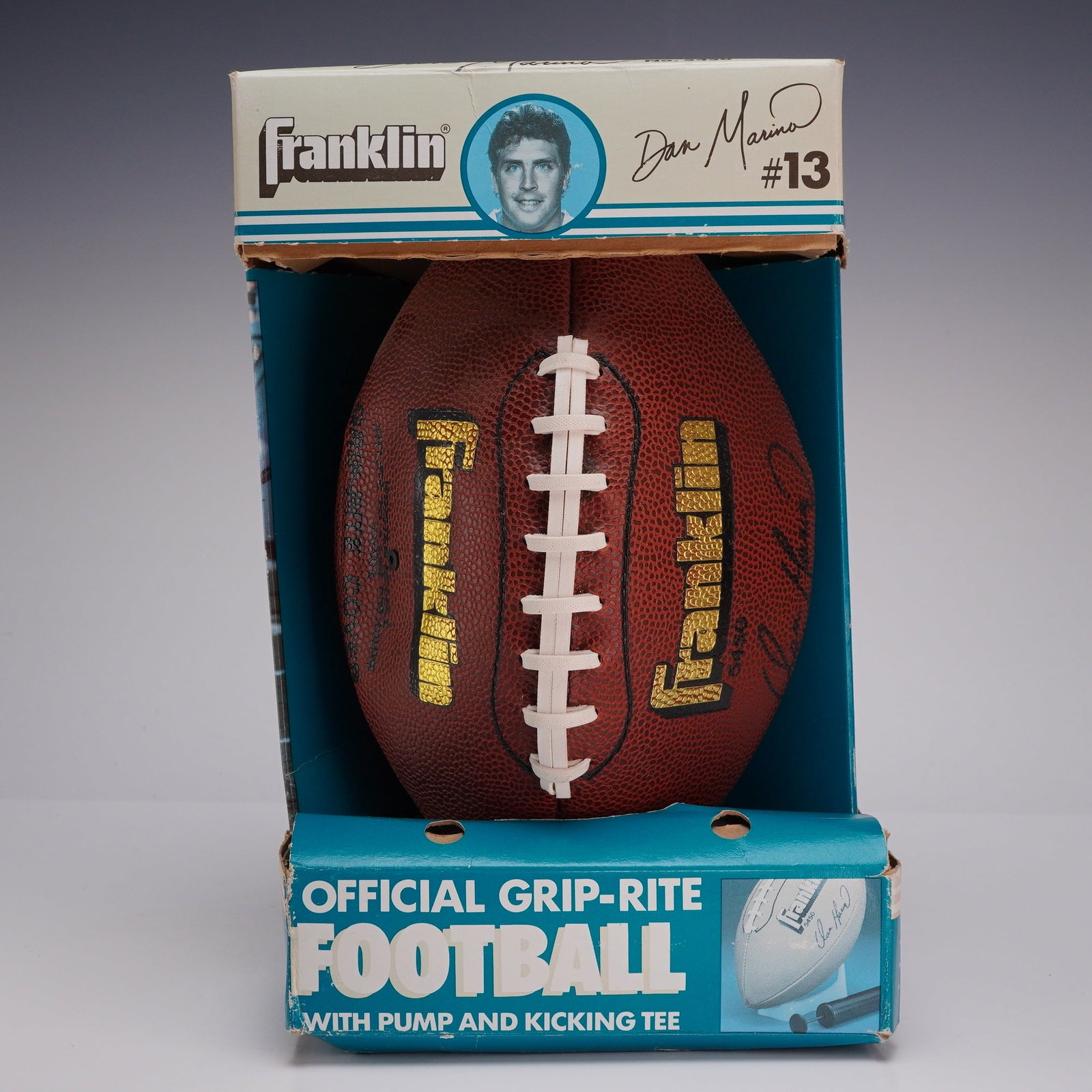 Franklin Dan Marino Official Grip-Rite Football Pump & Kicking Tee Set: A vintage Franklin Sports Industries Dan Marino football set, model number DC 83. The set includes an Official Grip-Rite football constructed from brown pebbled-grain synthetic material with white