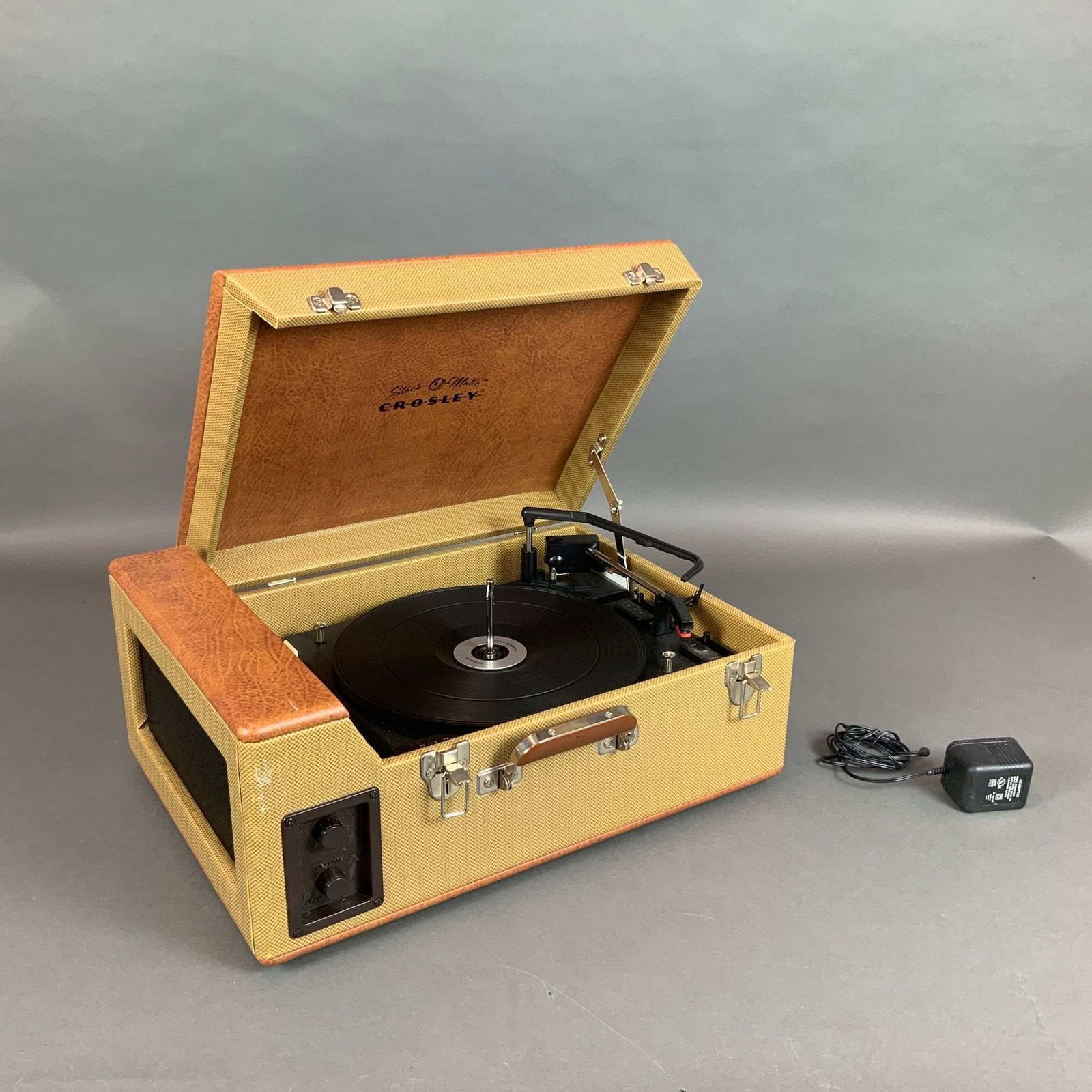 Crosley CR89 Stack-O-Matic Traveler Portable 3-Speed Record Player: This is a Crosley CR89 Stack-O-Matic Traveler portable suitcase-style record player. The unit features a two-tone cabinet design with brown textured faux-leather covering the top and bottom panels
