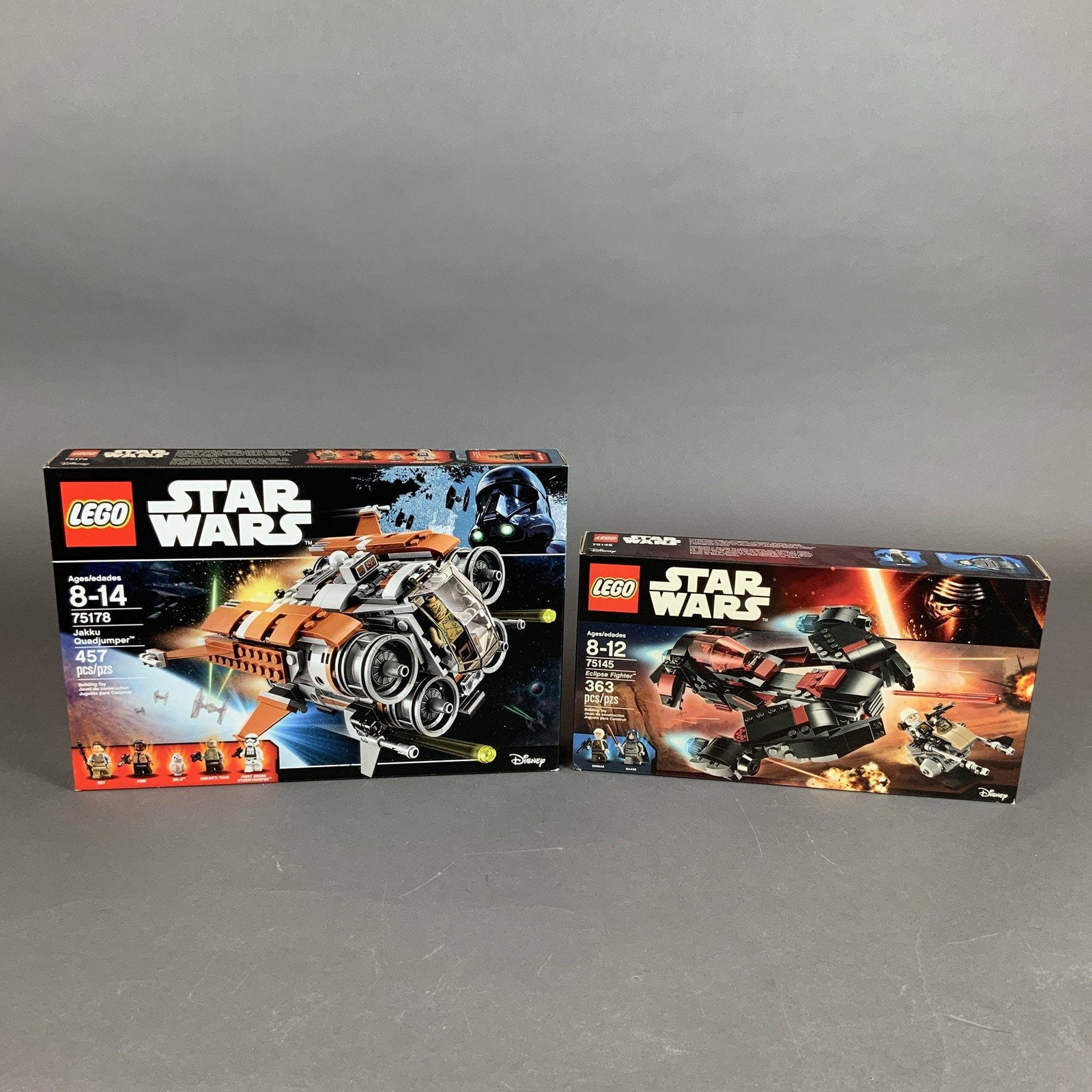 Two LEGO Star Wars Construction Sets 75145 and 75178: This lot features two original LEGO Star Wars construction sets in their original retail packaging. The collection includes Set 75145 Eclipse Fighter and Set 75178 Jakku Quadjumper. Set 75145 is based
