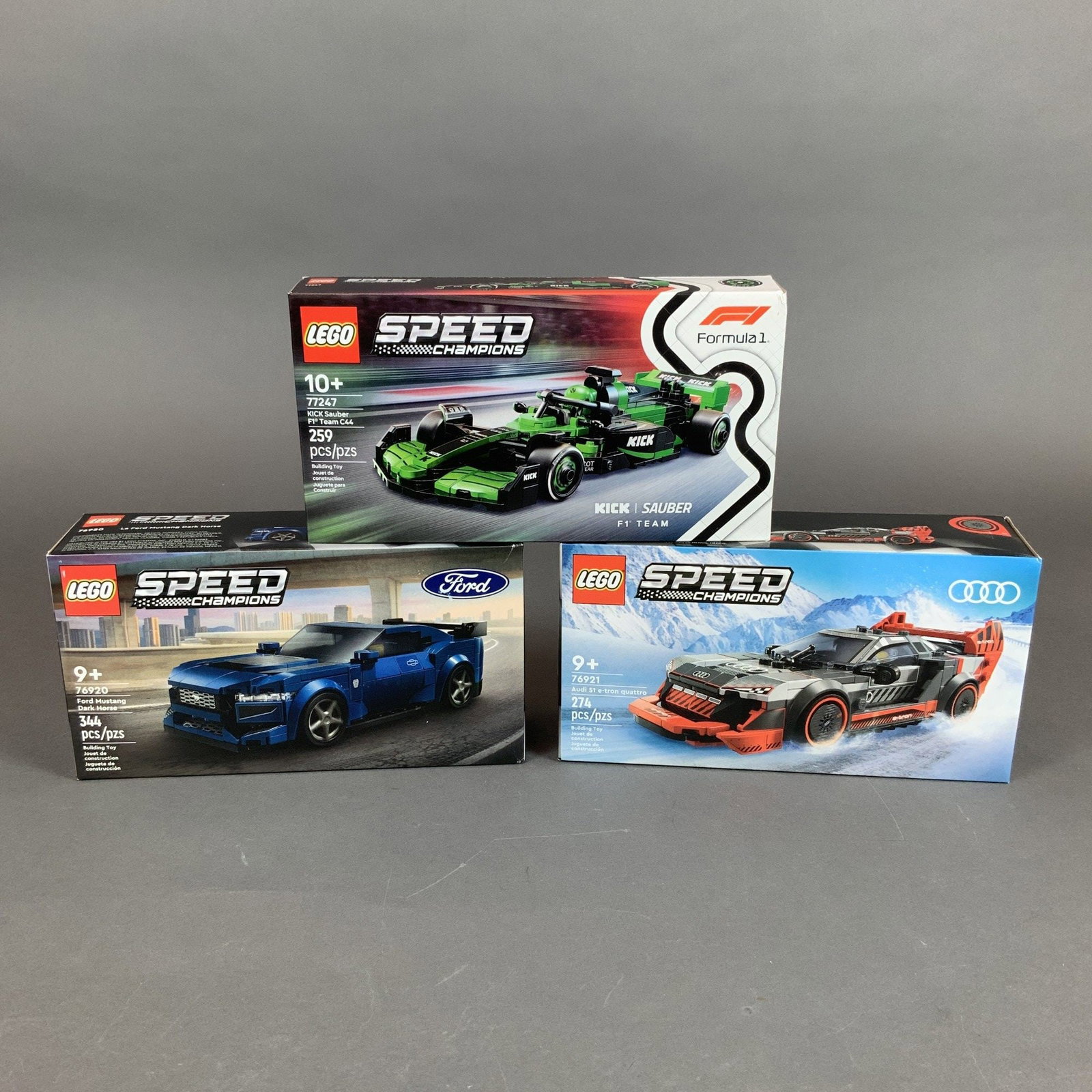 Three LEGO Speed Champions Model Building Sets Numbers 77247 76920 and 76921: This lot features three building sets from the LEGO Speed Champions series. These models are constructed from plastic bricks and represent various high-performance automotive vehicles. The group inclu