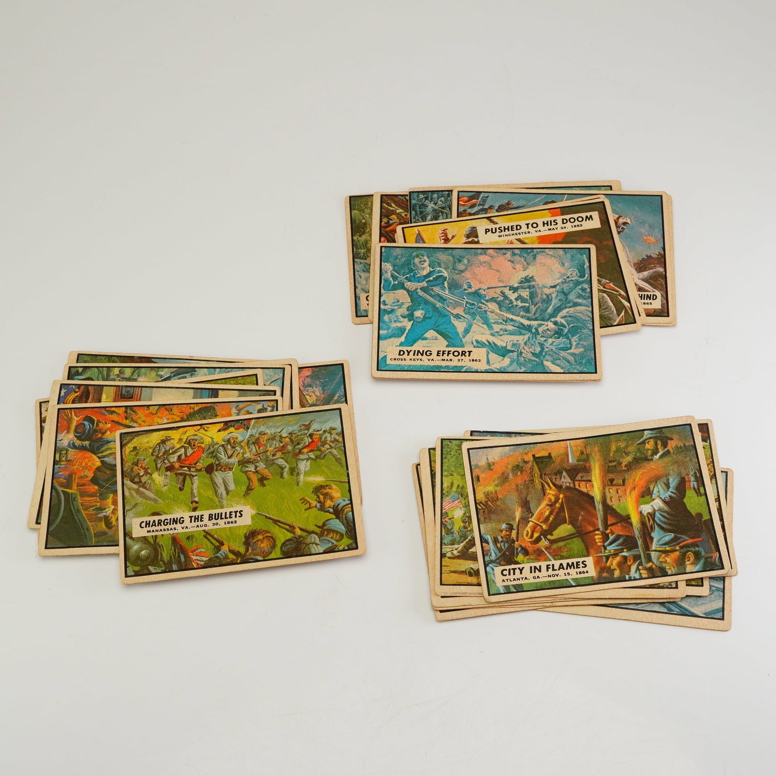 A Collection of 20 Plus 1962 Topps Civil War News Trading Cards: This collection of 20 plus Civil War News collectible trading cards was issued in the early 1960s by Topps. Each card features a full-color illustration on the obverse depicting various historical eve