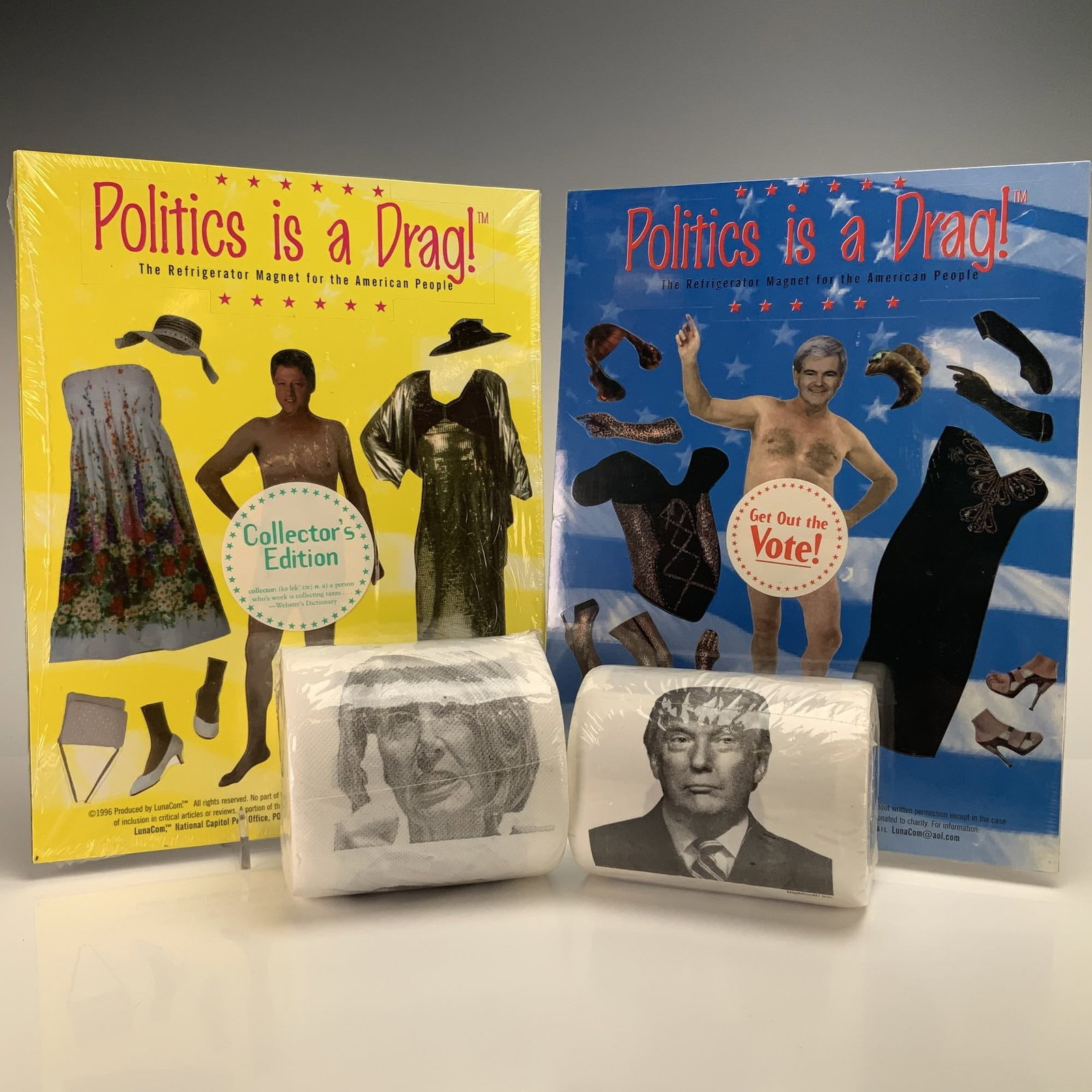 4pc Trump and Pelosi Toilet Paper and LunaCom Politics is a Drag Magnets: A collection of four novelty political memorabilia items including Trump and Pelosi toilet paper and LunaCom Politics is a Drag! magnet sets. The two dress-up refrigerator magnet sets, produced by Lun