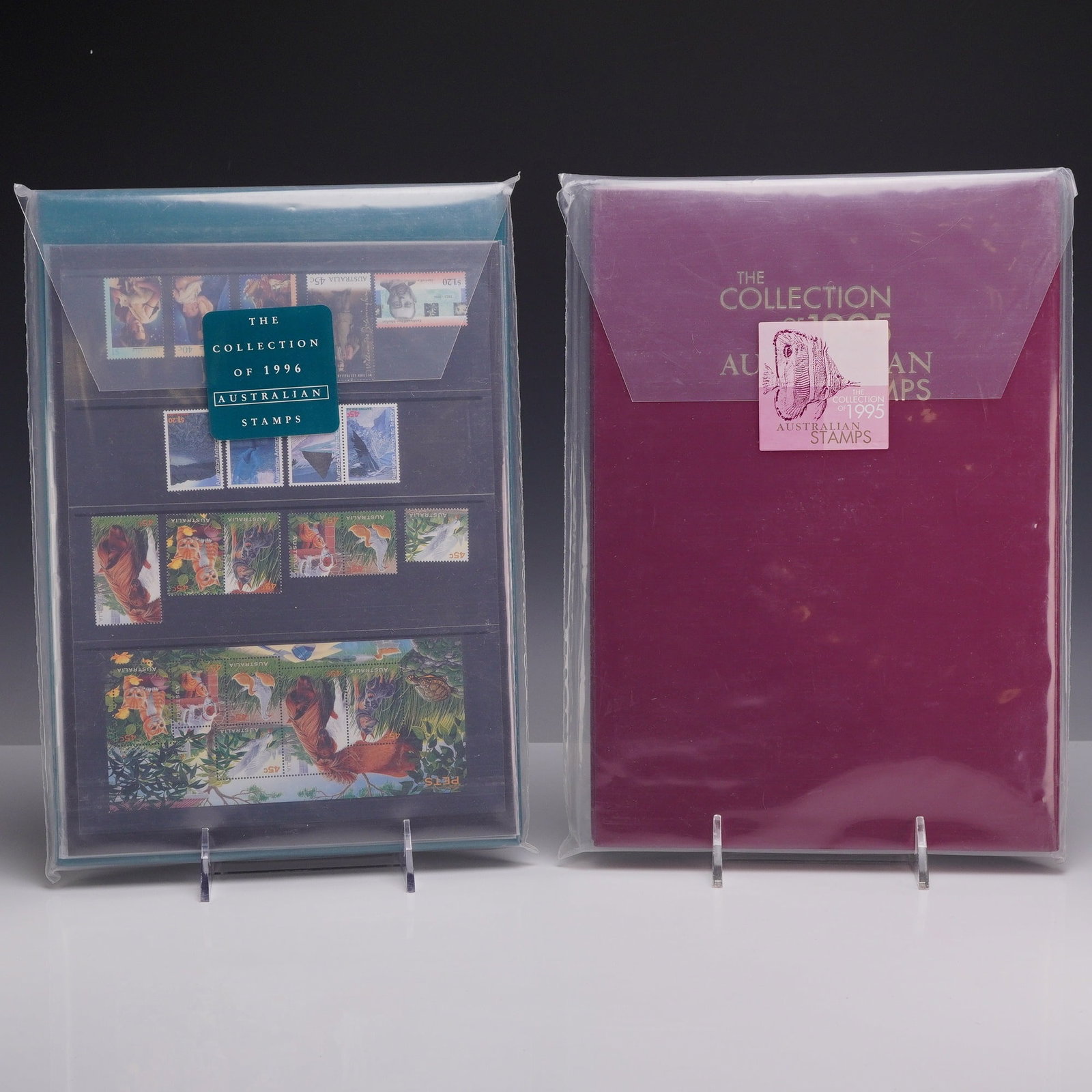 Set of Two Australian 1995 and 1996 Annual Stamp Collections, Deluxe Editions, MNH: This lot consists of two official Australia Post Deluxe Edition annual stamp collections for the years 1995 and 1996. Each volume is housed in a matching slipcase and remains in the original clear pla