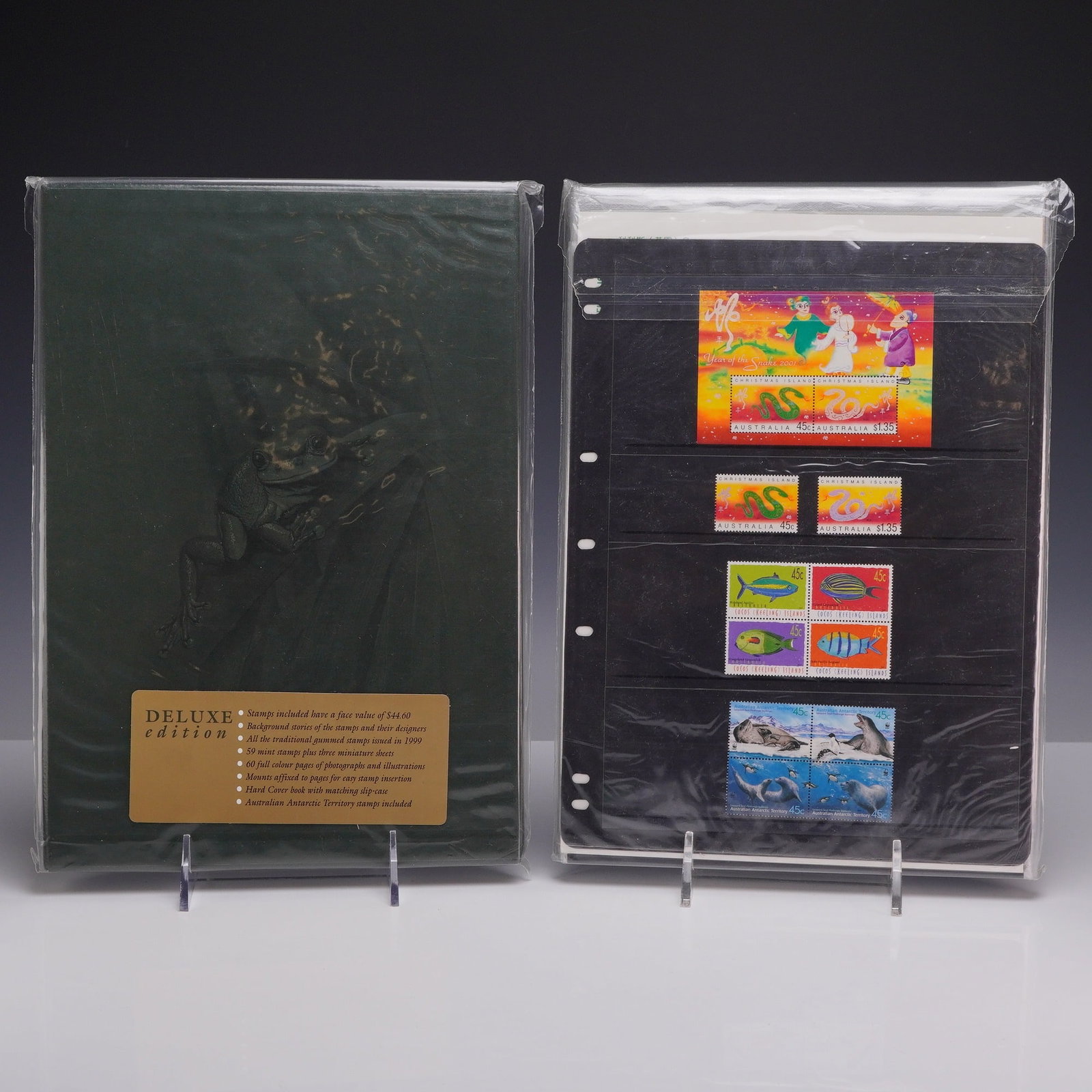 Two Australian 1999 and 2000 Deluxe Annual Stamp Collections and 2001 Souvenir Sheets: This lot comprises two Australia Post deluxe edition annual stamp collection albums for the years 1999 and 2000, along with a selection of loose mint stamps and souvenir sheets from 2001. The 1999 Del