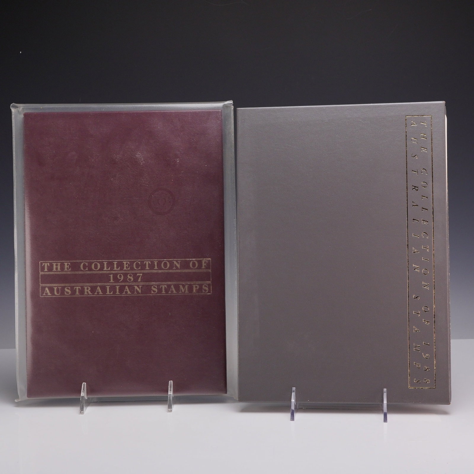 Two Sets AU 1987 and 1988 Australia Post Annual Stamp Year Collections: Two official Australia Post annual stamp year collections comprising the full philatelic emissions for 1987 and 1988. The 1987 volume features a maroon textured hardcover with gold foil-stamped title 