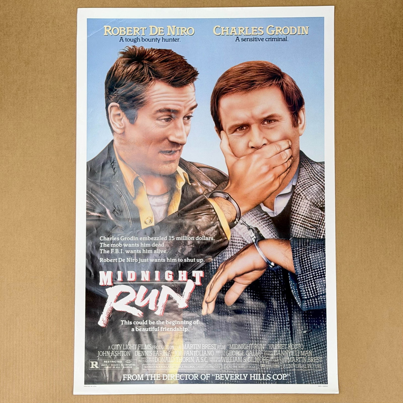 Midnight Run 1988 Theatrical Movie Poster: A theatrical movie poster for the 1988 film Midnight Run starring Robert De Niro and Charles Grodin with graphics and production credits for Universal Pictures. Dimensions: 24.50"L x 39.00"H Weight: 1