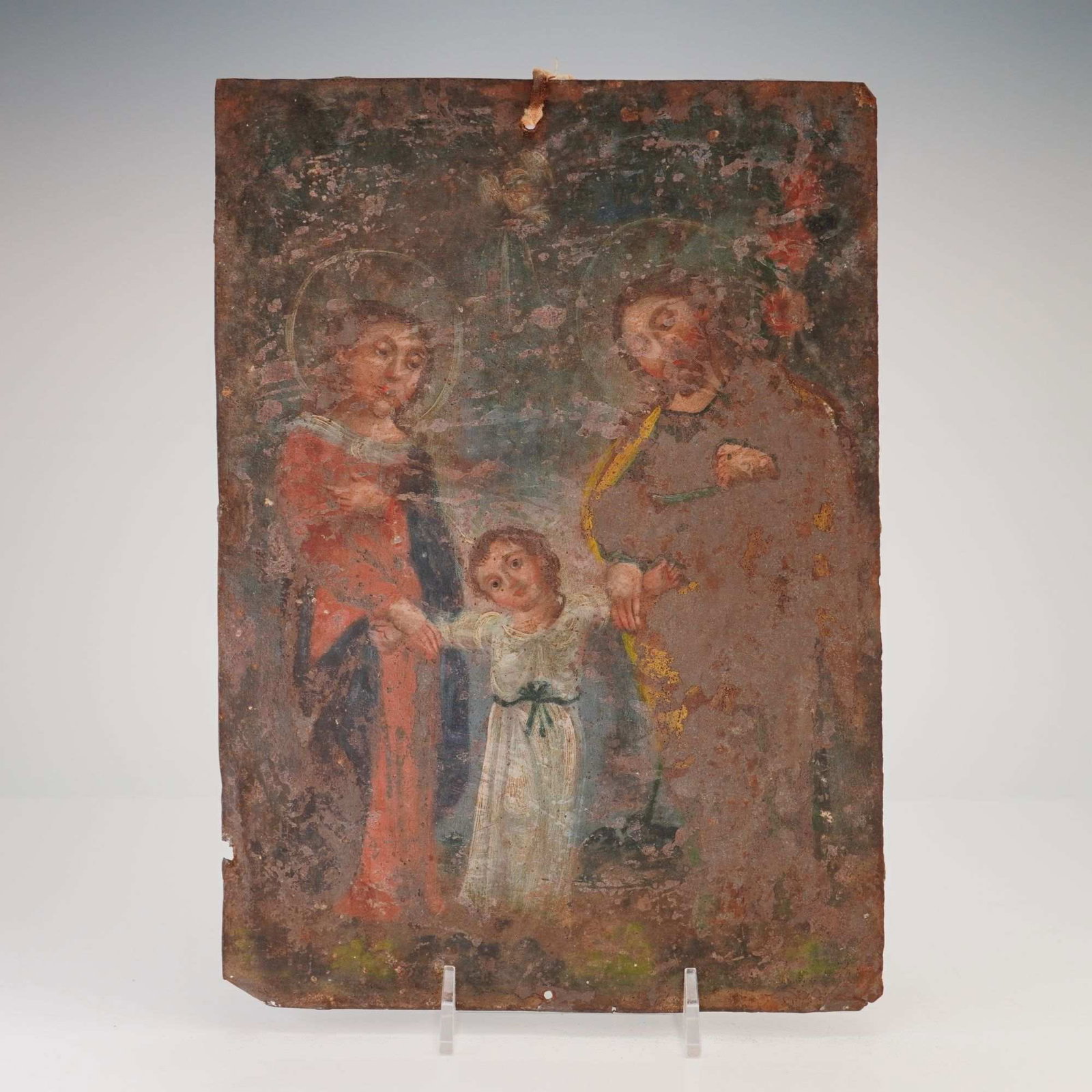 19th Century Mexican School Retablo of the Holy Family Painted on Tin: This Mexican school painting is a devotional work on tin, known as a retablo. The composition depicts the Holy Family, with the central Christ Child led by the Virgin Mary on the left and Saint Joseph