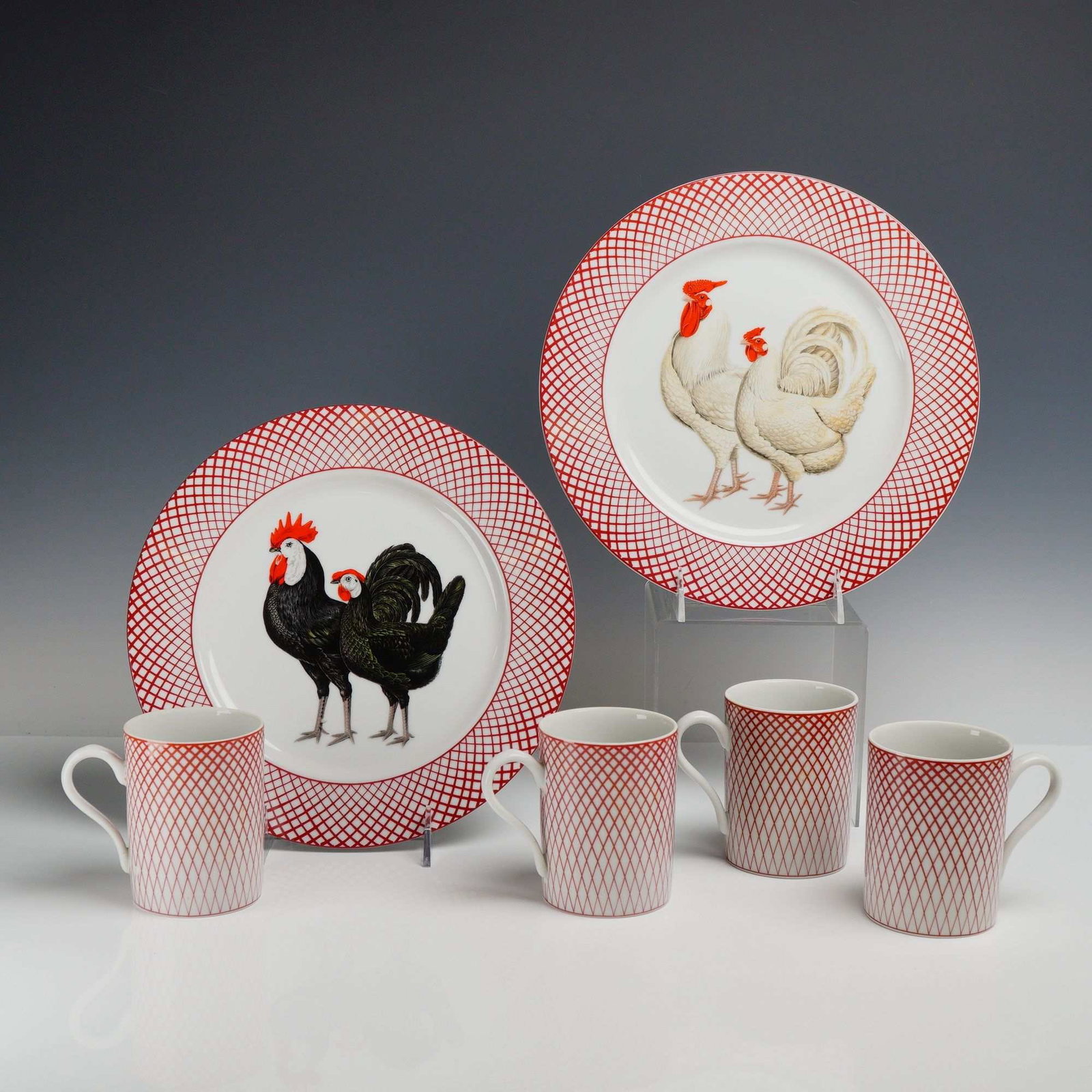 6pc Haldon Group Devonshire Rooster Plate and Cup Set: This six-piece ceramic set from The Haldon Group features the Devonshire pattern, dated 1979. The set includes two large circular plates and four coordinating mugs. Each plate is decorated with a cent