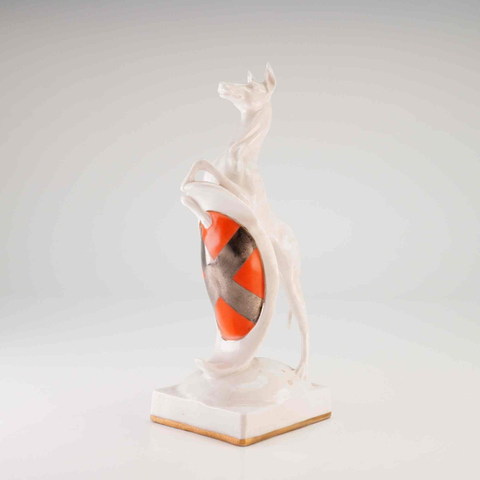 Rare Michael J. Sutty The King's Greyhound Figurine: A white glazed porcelain figurine titled The King's Greyhound, designed by Michael J. Sutty. The piece is modeled as a rearing greyhound with an elongated neck and slender proportions supporting an he
