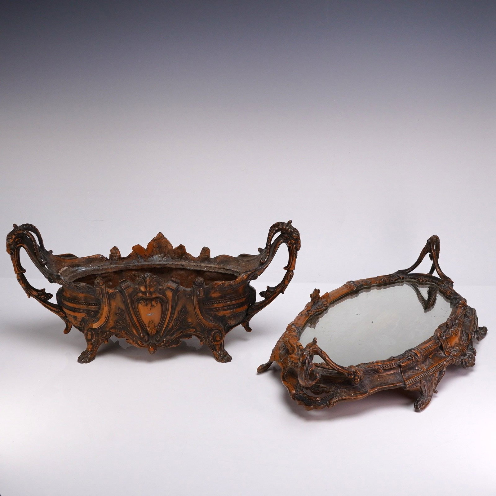 Art Nouveau Metal Surtout de Table Ram Motif Bowl with Mirrored Tray: This two-piece Art Nouveau decorative centerpiece set, also known as a surtout de table, consists of a handled jardiniere and a matching mirrored plateau. The set is constructed from cast metal with a