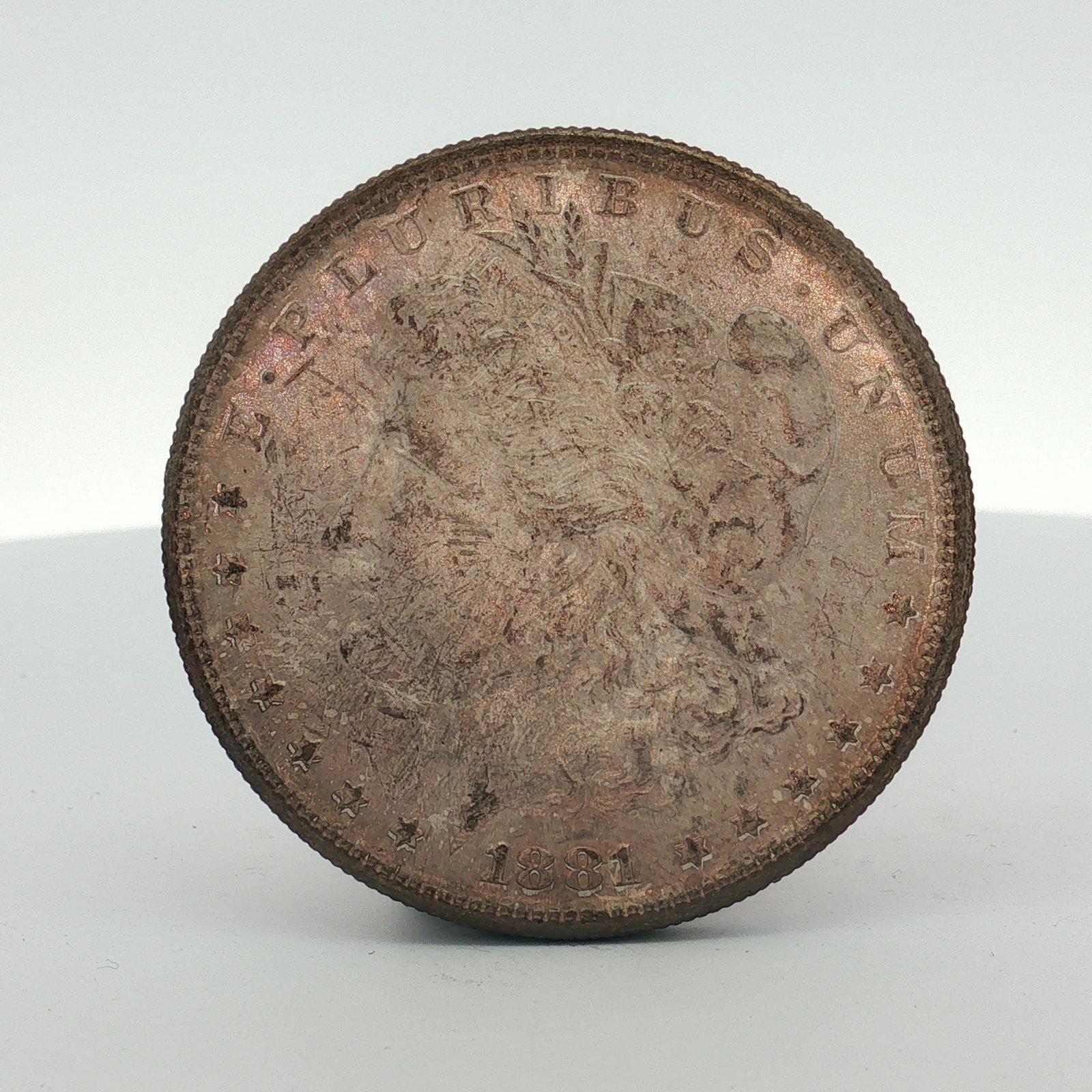 1881-S US One Dollar Morgan Silver Dollar, Circulated: This 1881 US Morgan silver dollar was struck at the San Francisco Mint. The coin is composed of 90 percent silver and 10 percent copper with a fineness of .900. It features the standard Morgan dollar 