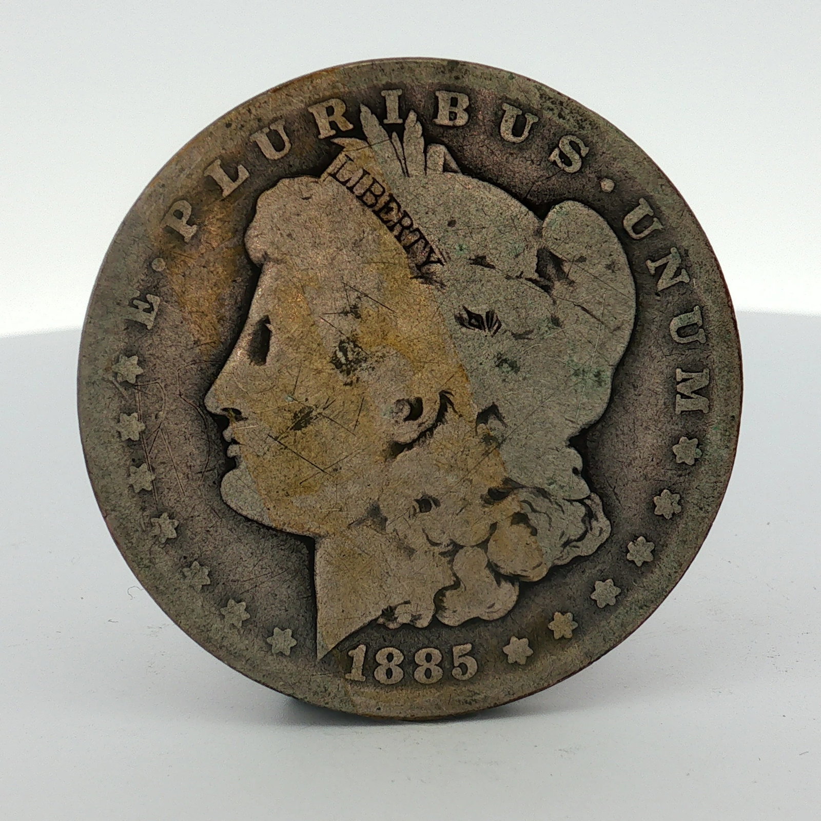 1885-O US Morgan Silver Dollar Coin Circulated: This US Morgan silver dollar was struck at the New Orleans Mint in 1885. The coin is composed of 90% silver and 10% copper (.900 fine). It features the O mint mark on the reverse, located above the de