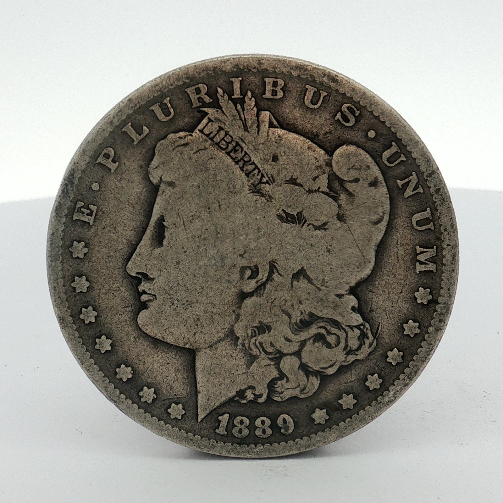 1889-O US Morgan Silver Dollar Coin Circulated: This US Morgan dollar was struck at the New Orleans mint in 1889. The coin is composed of 90% silver and 10% copper. It features the Liberty Head obverse and the Eagle reverse. An O mint mark is locat